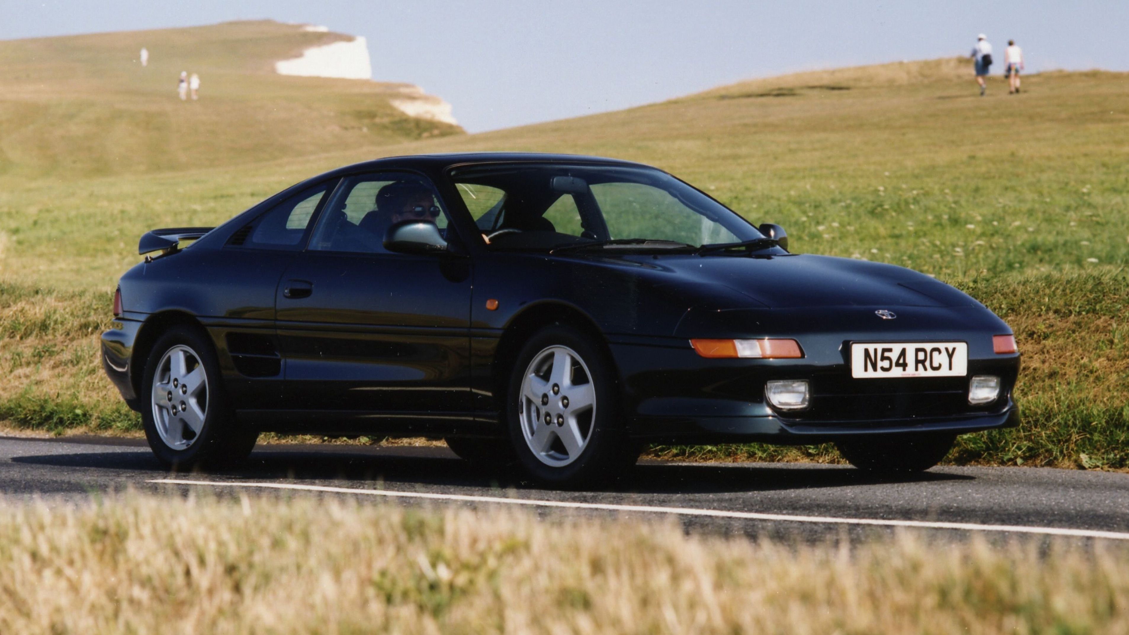 Black 1990s Toyota MR2 at Seven Sisters cliffs