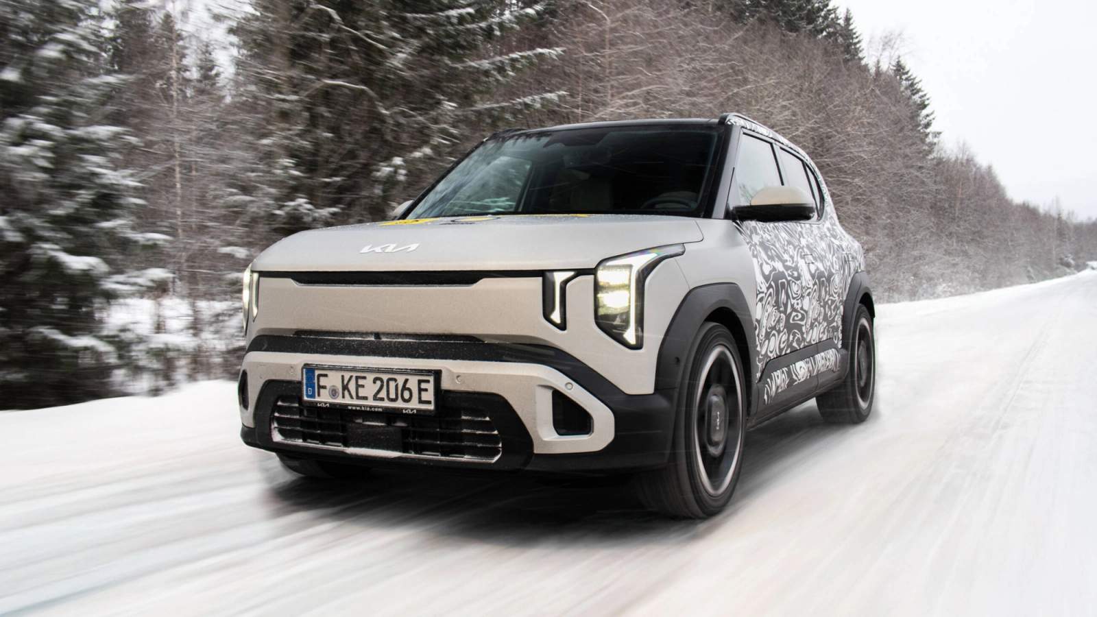 White Kia EV2 driving in the snow