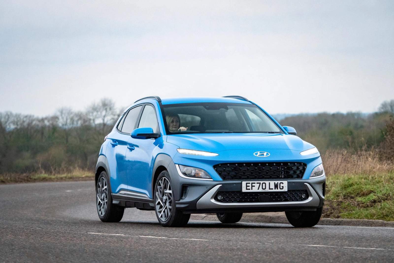 Blue Hyundai Kona driving
