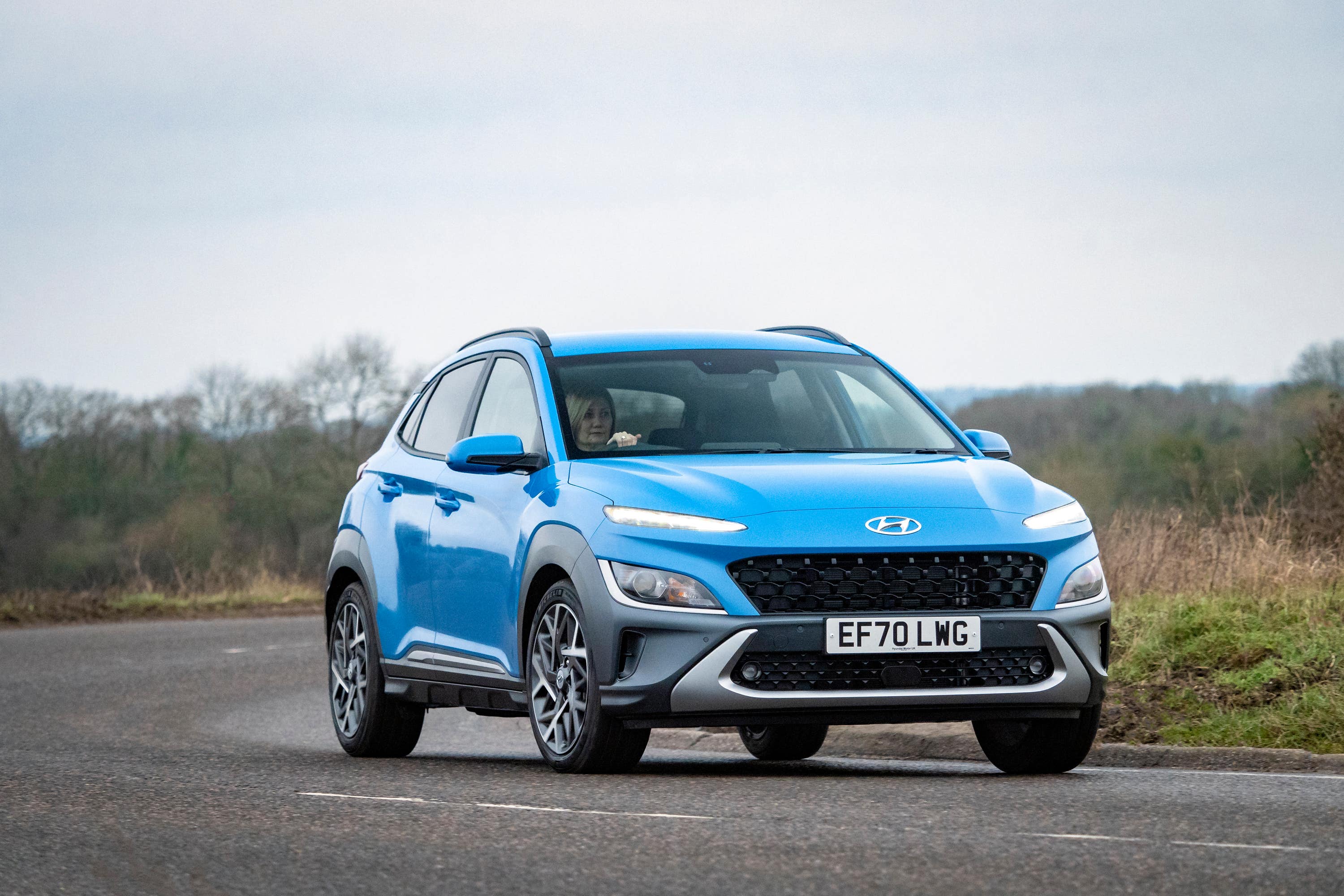Blue Hyundai Kona driving