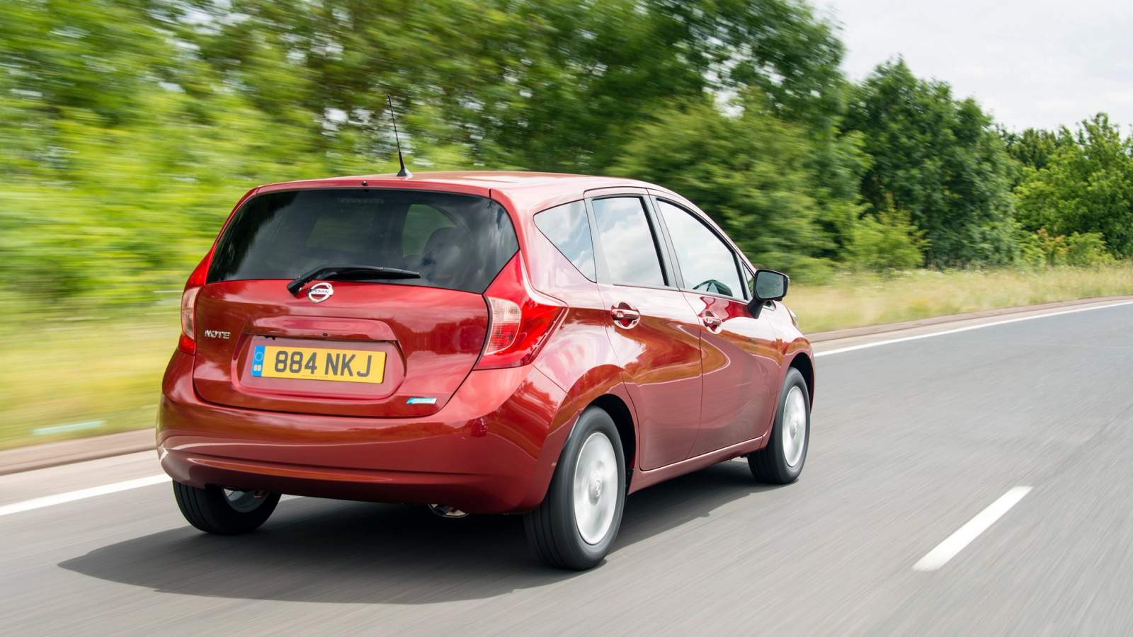 Red Nissan Note rear driving