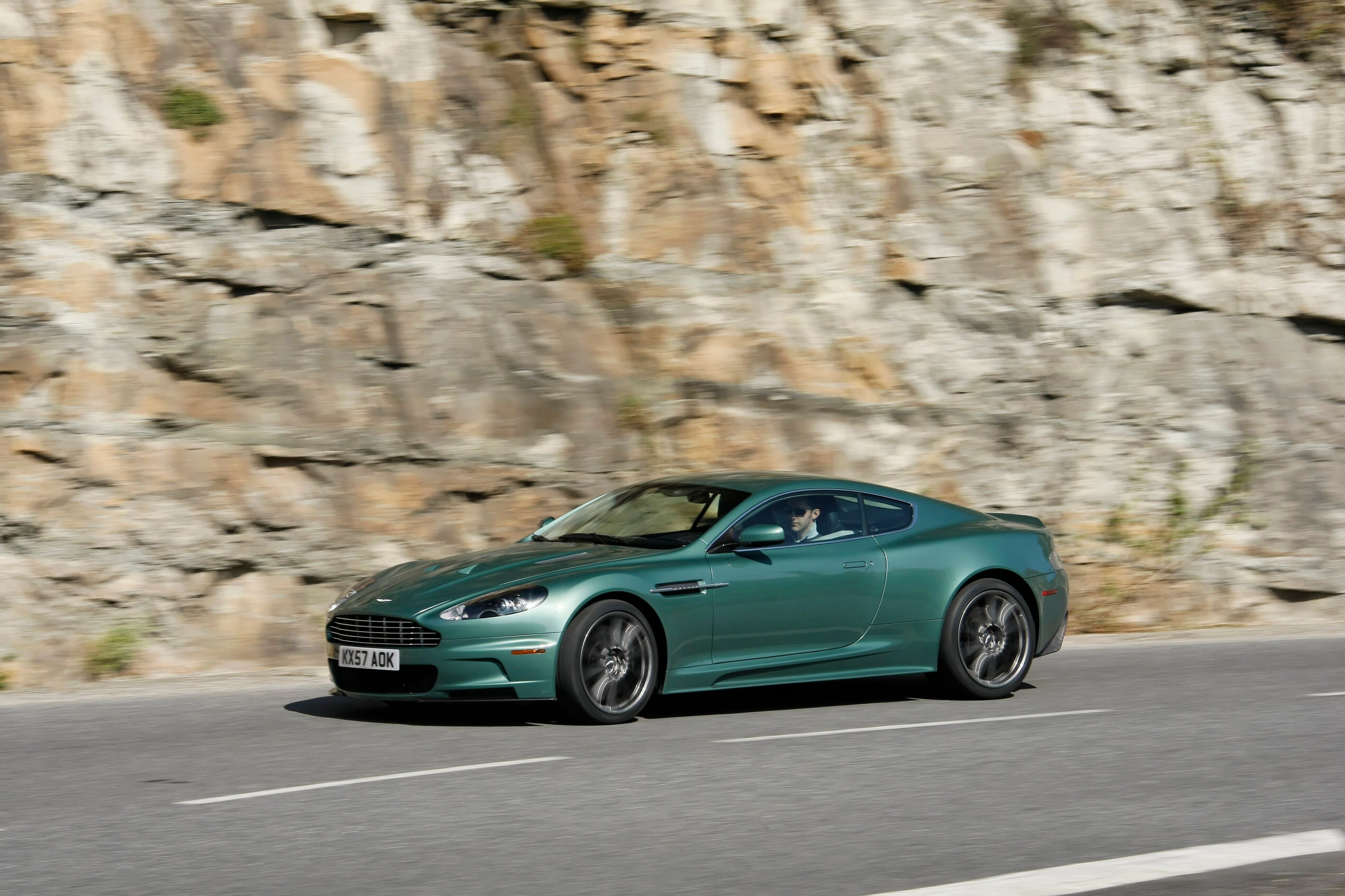 Green Aston Martin DBS driving