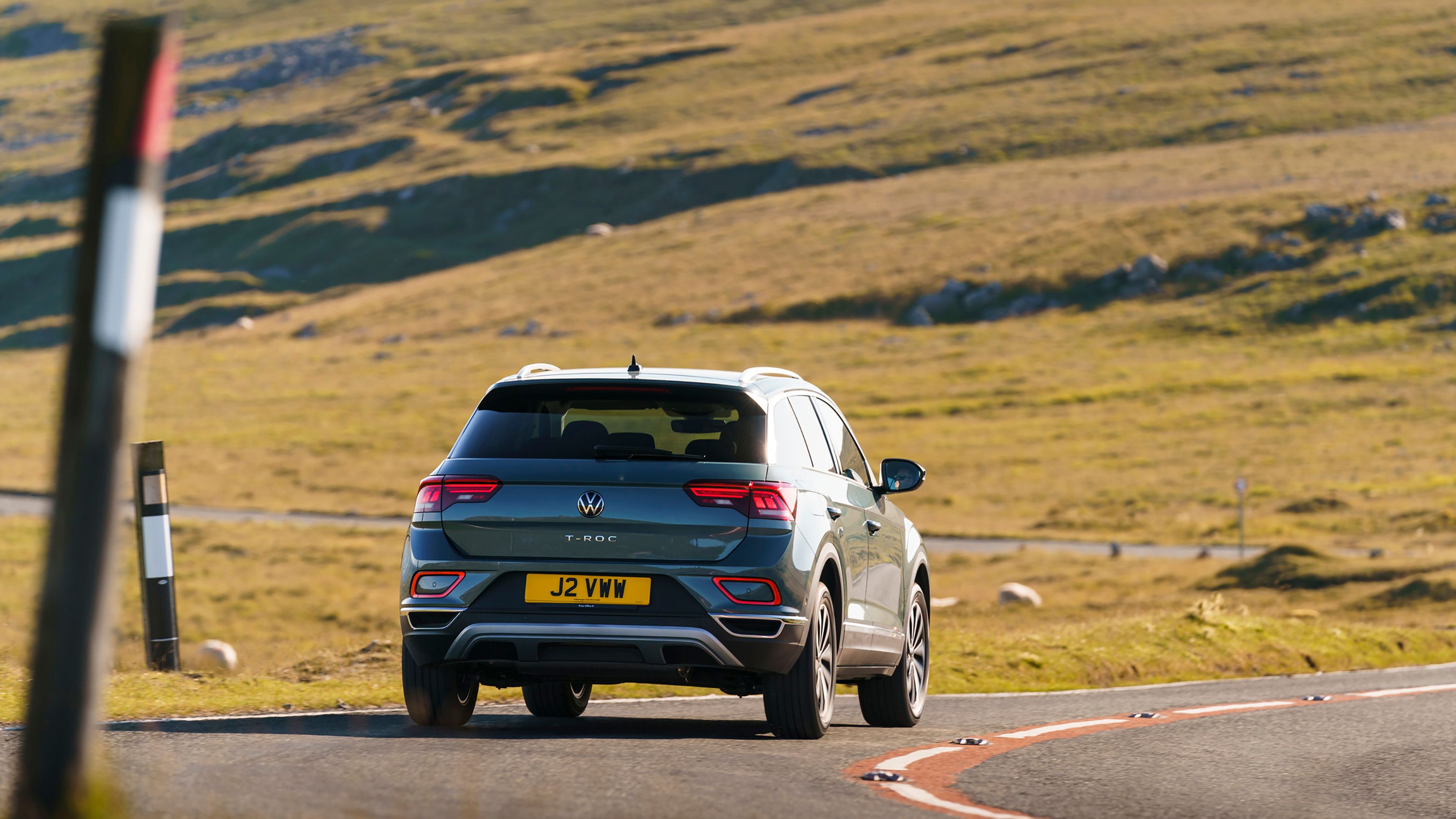 Blue Volkswagen T-Roc rear driving