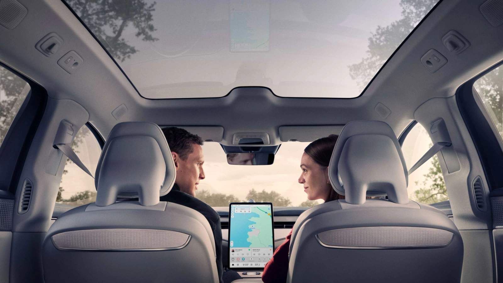Driver and passenger sitting in a cool car during a heatwave
