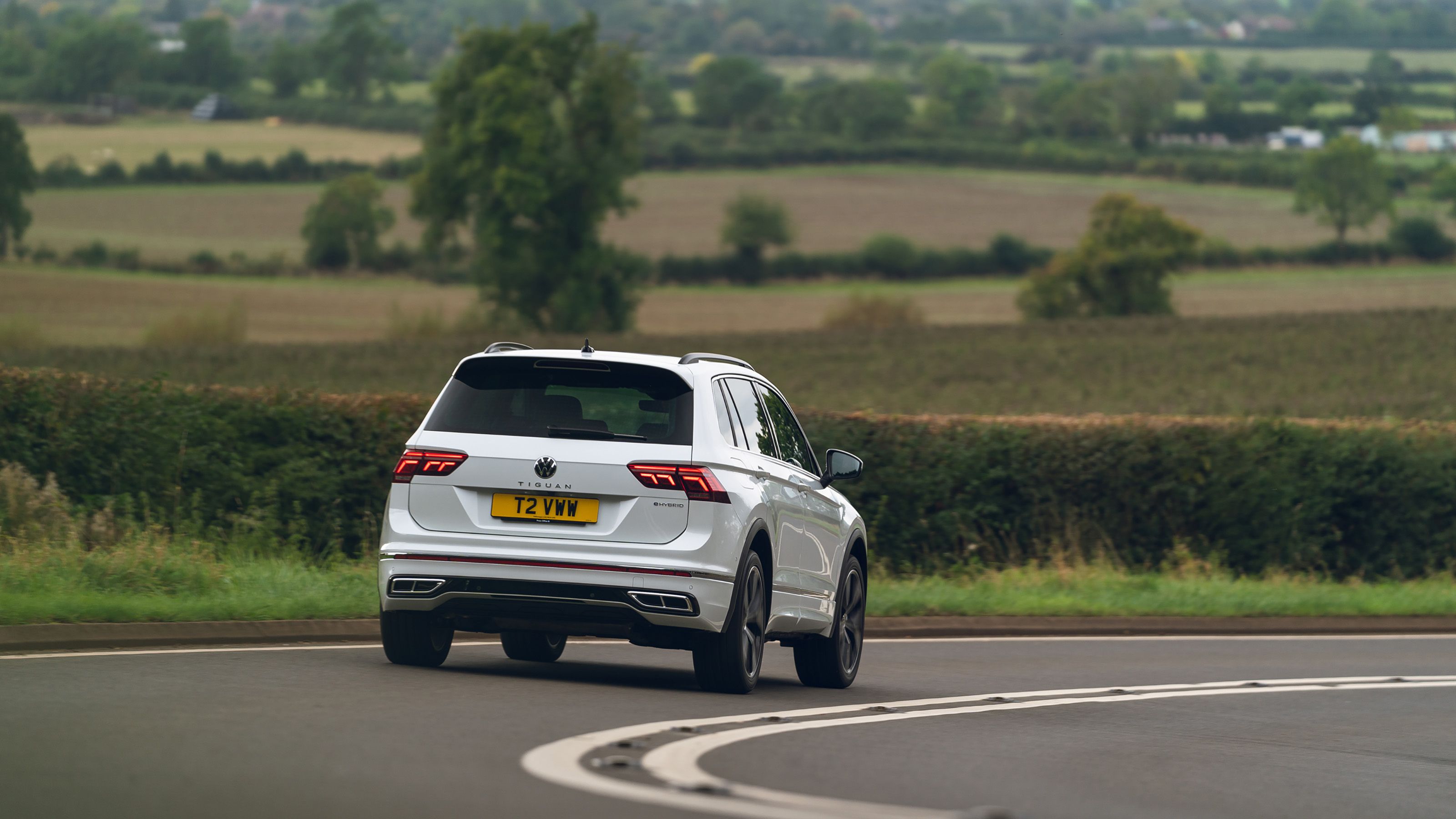 White Volkswagen Tiguan rear driving