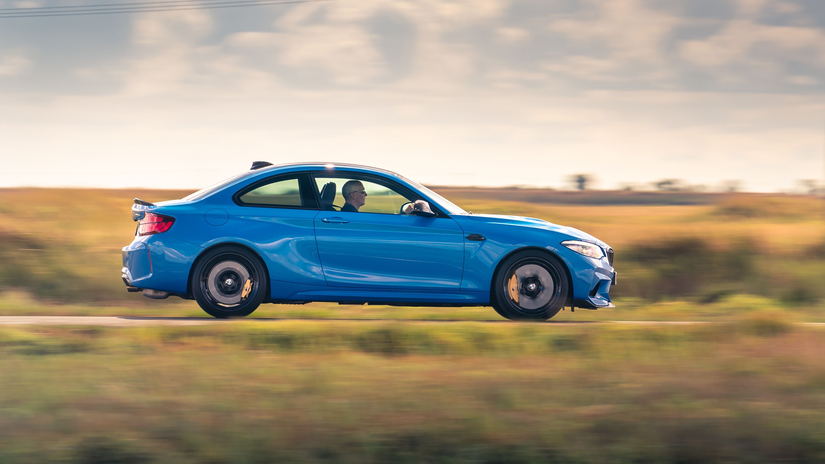 Blue BMW M2 CS side driving