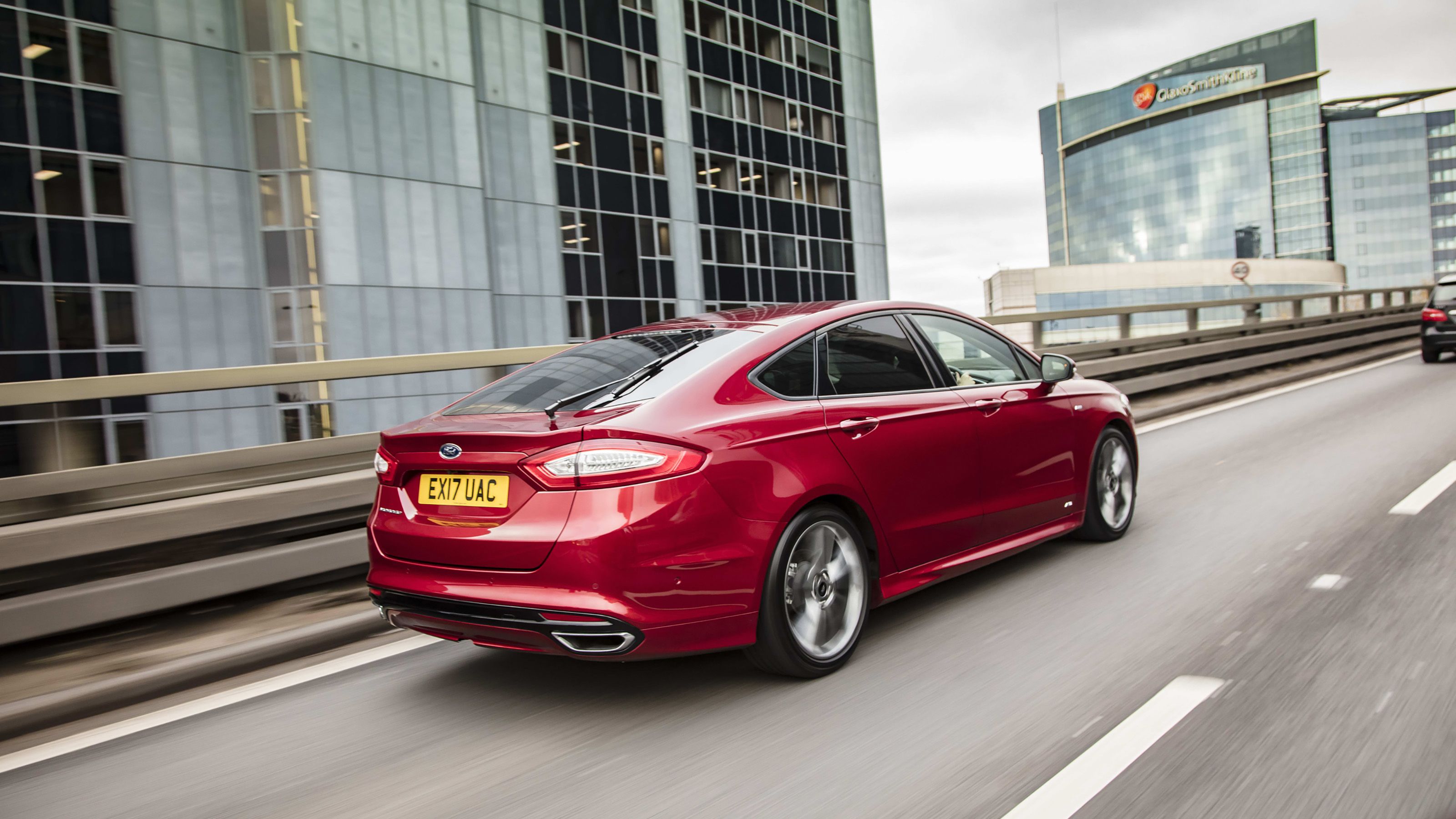 Red Ford Mondeo rear driving