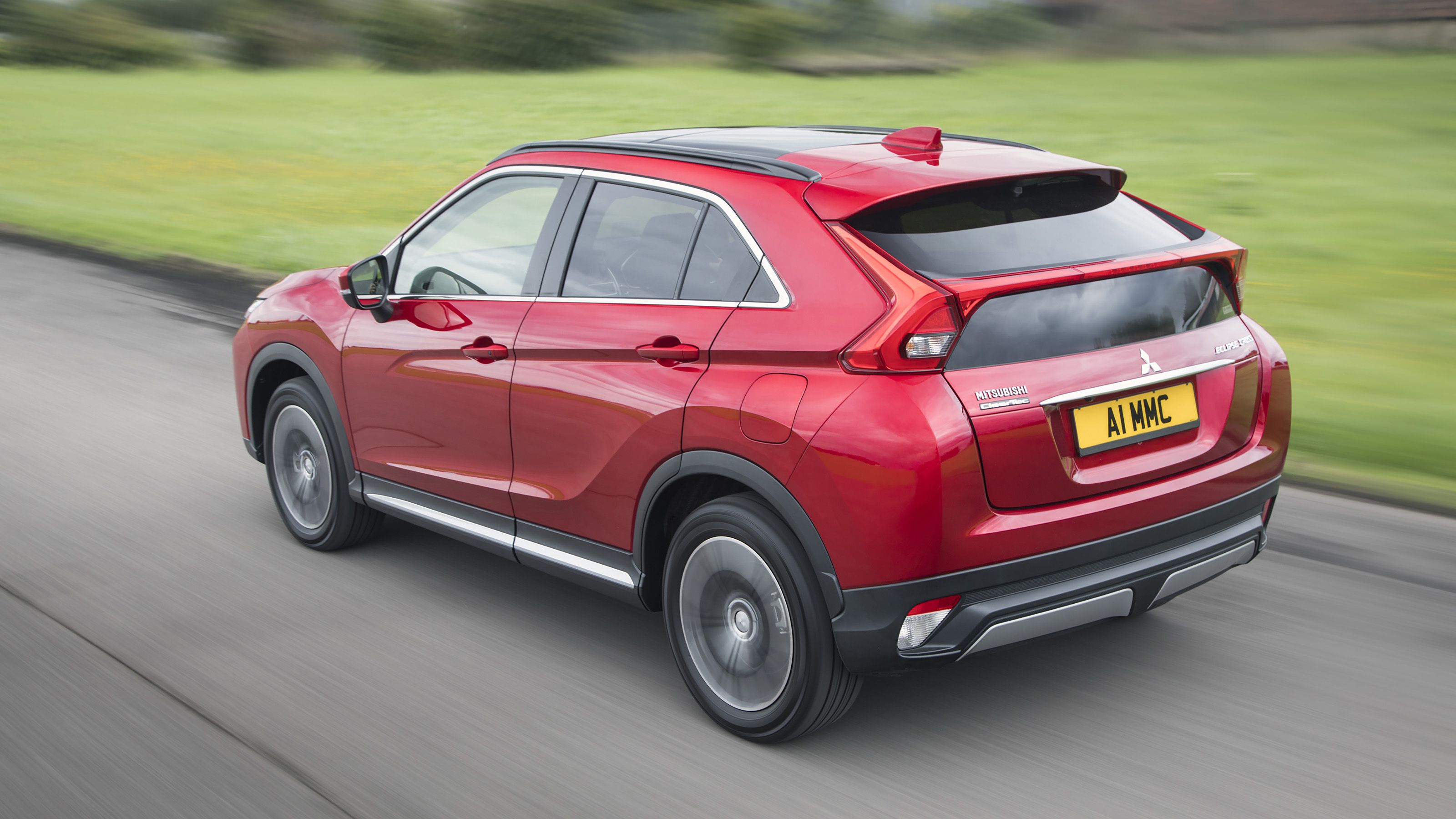 Red Mitsubishi Eclipse Cross rear driving