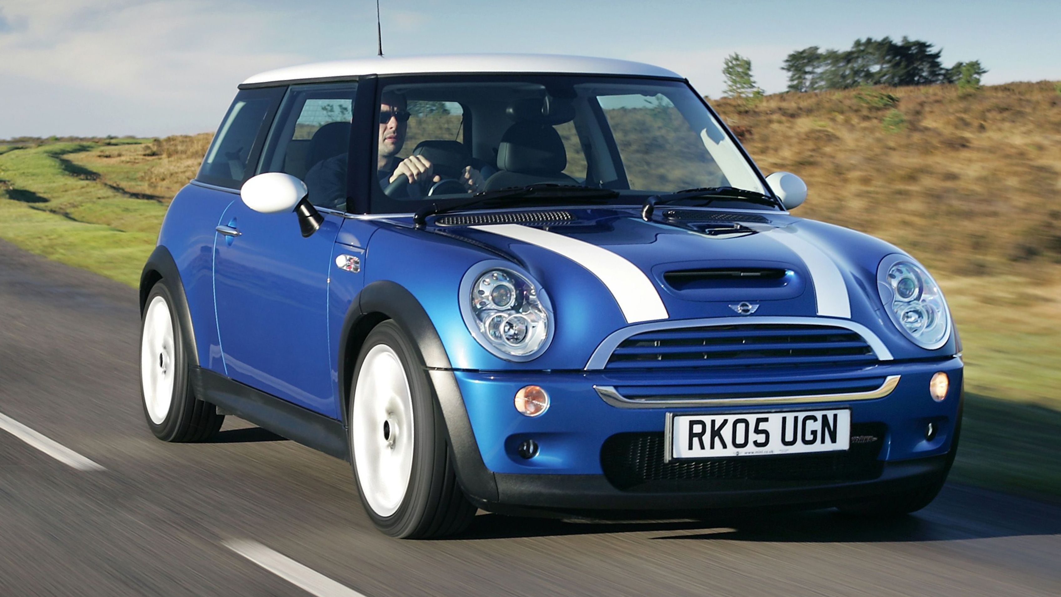 Blue MINI Cooper S driving on road