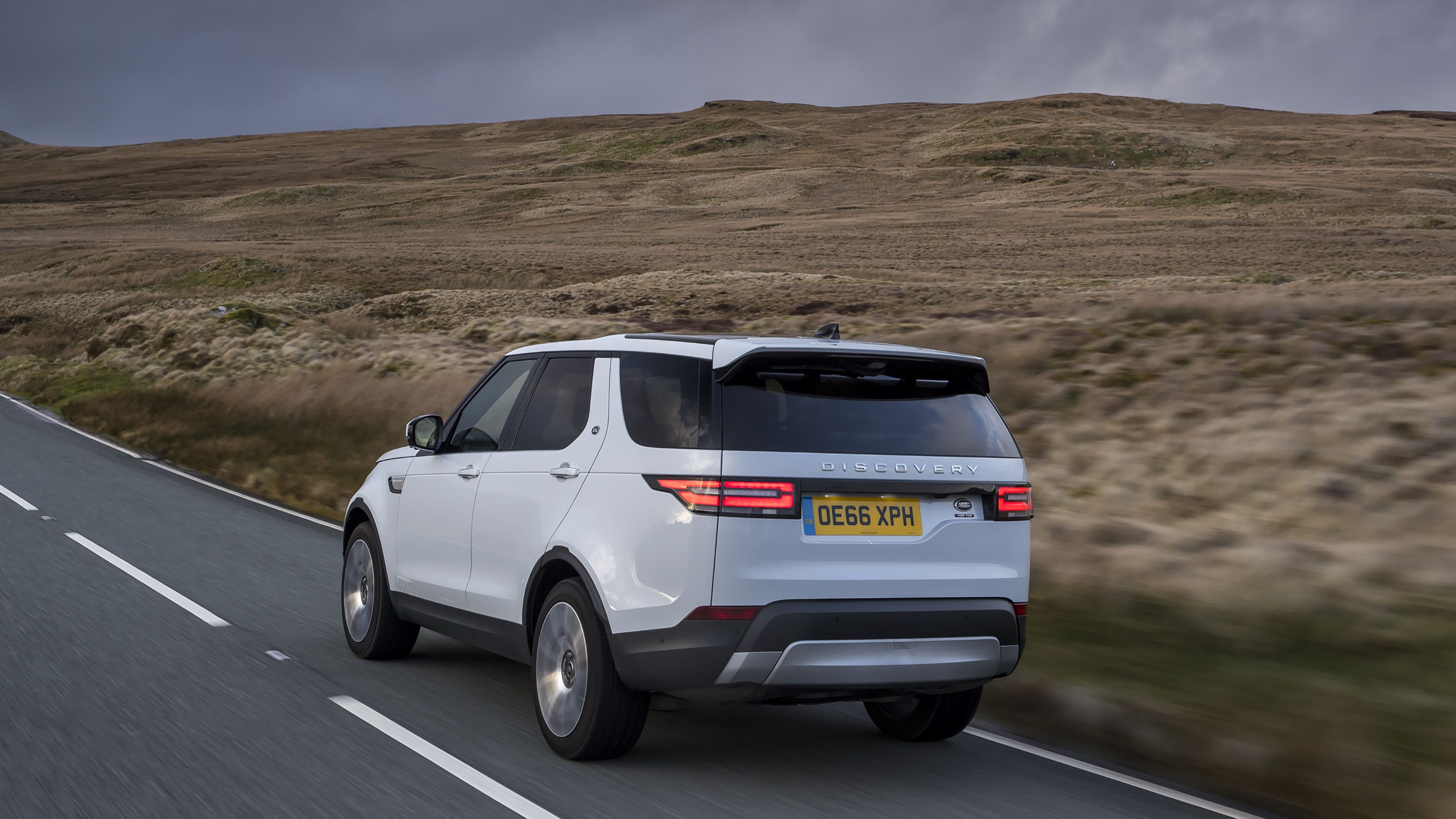 White Land Rover Discovery rear driving