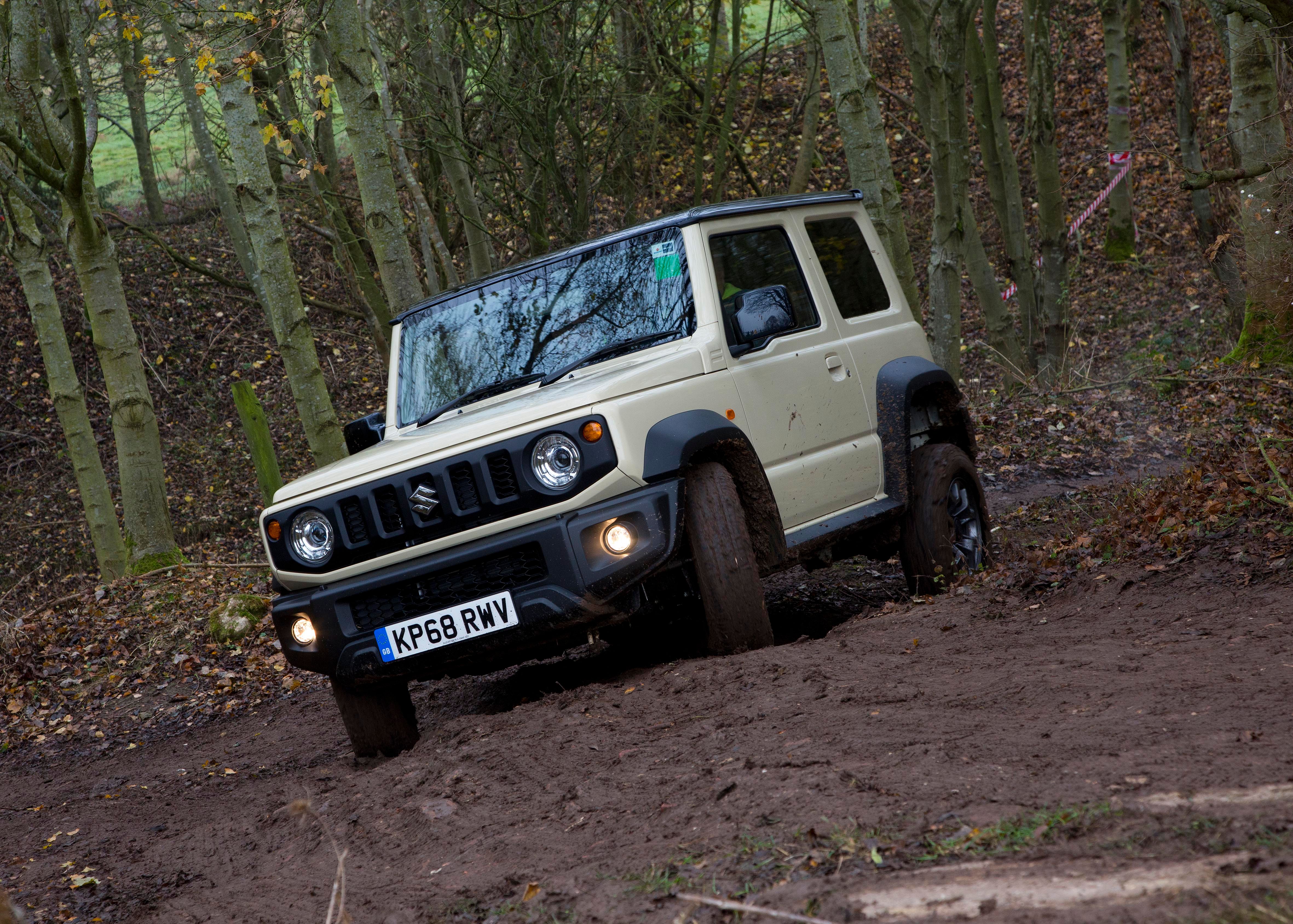 Beige Suzuki Jimny off-roading