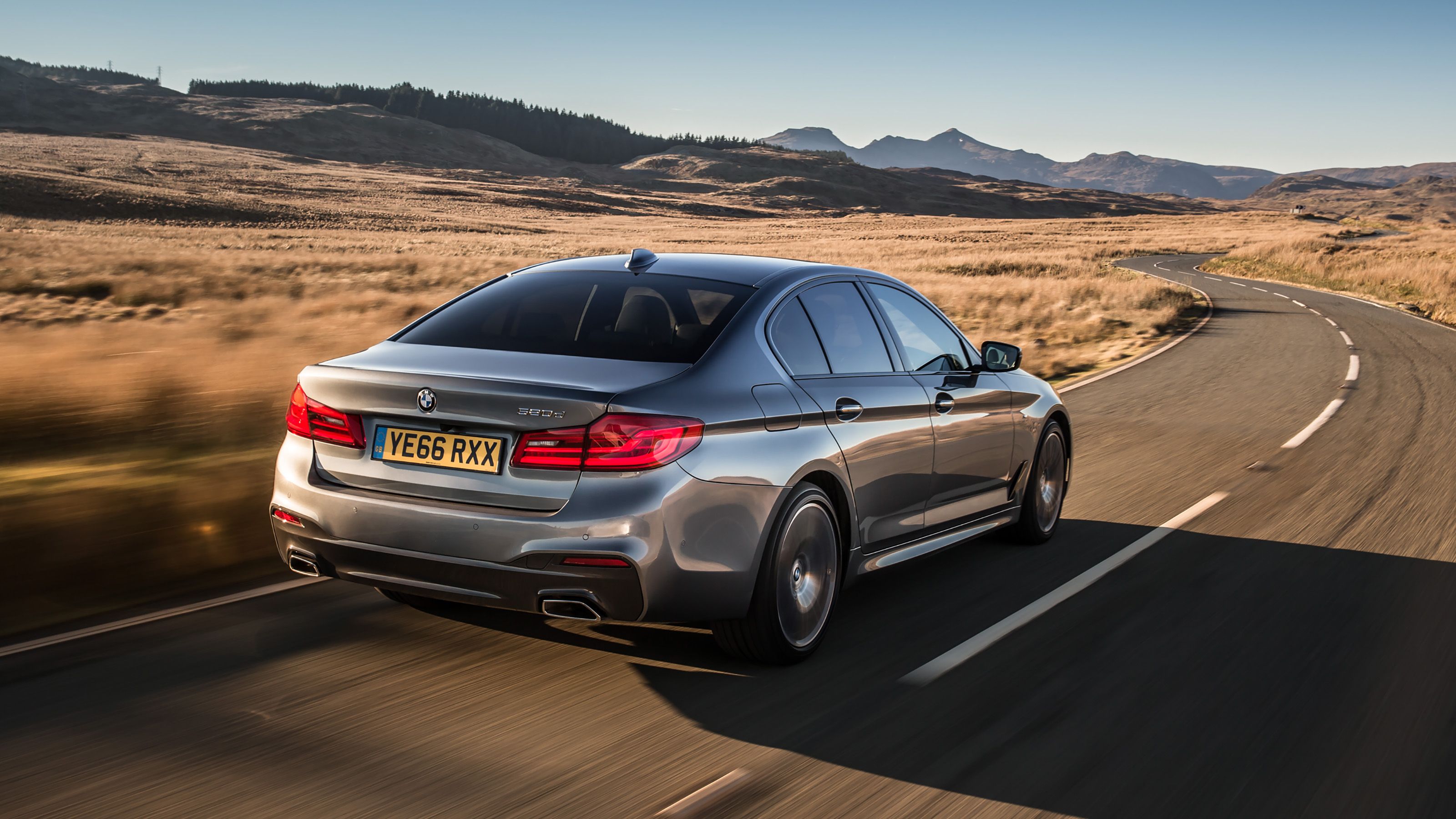 Grey BMW 5 Series rear driving