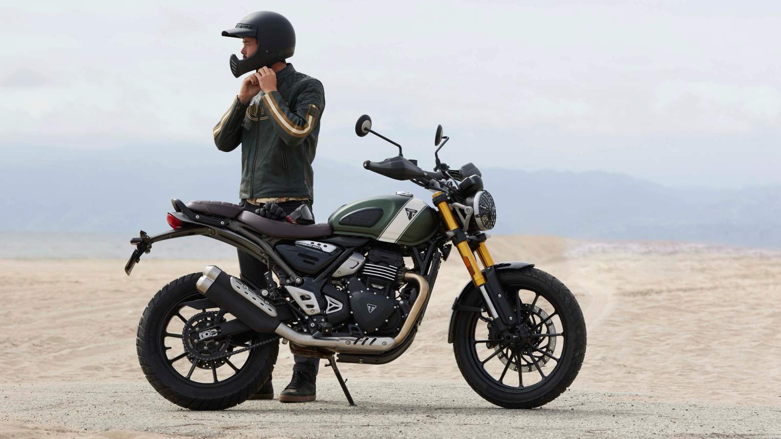 Man standing next to his Triumph Scrambler 400X