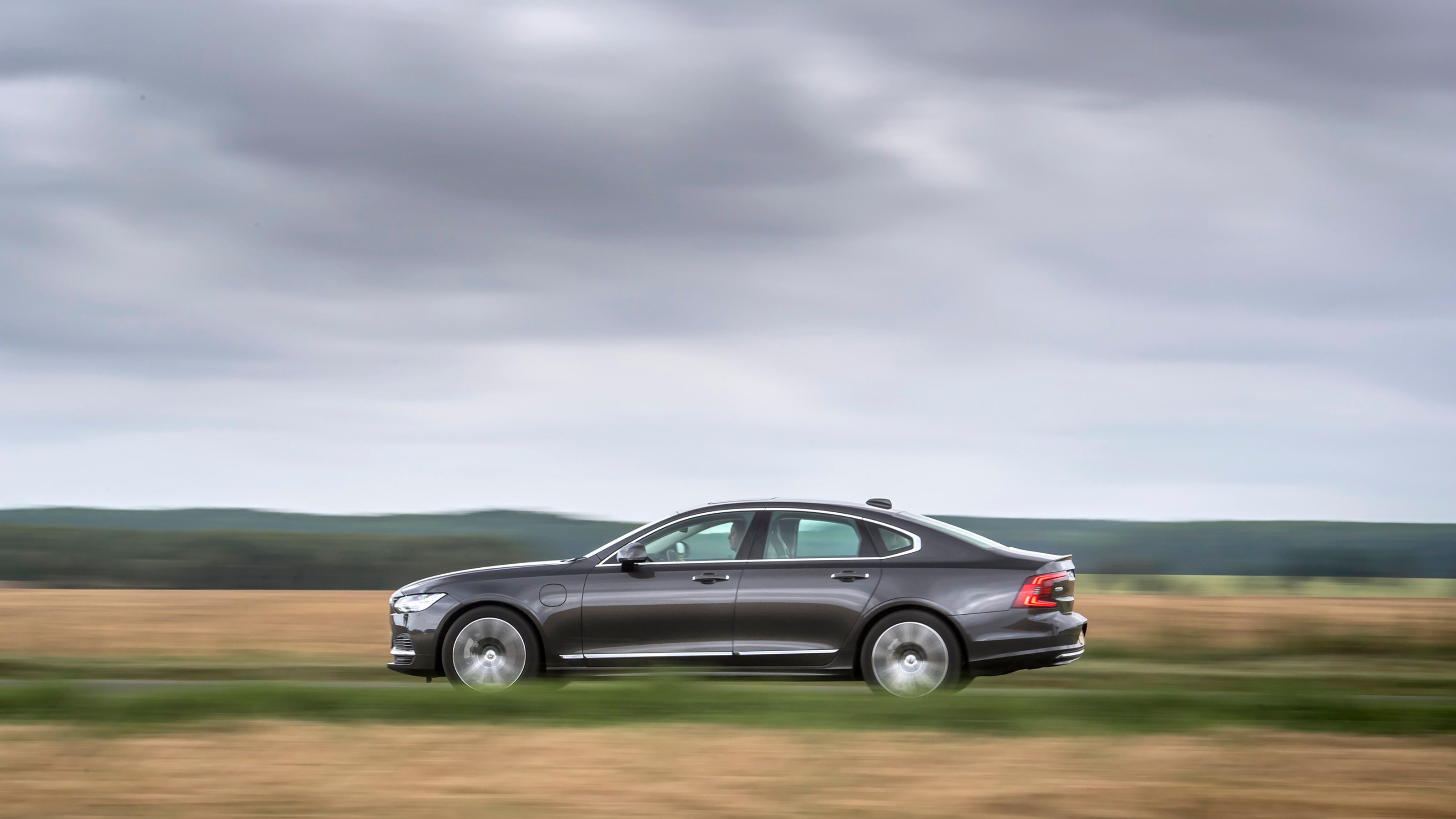 Brown Volvo S90 side driving