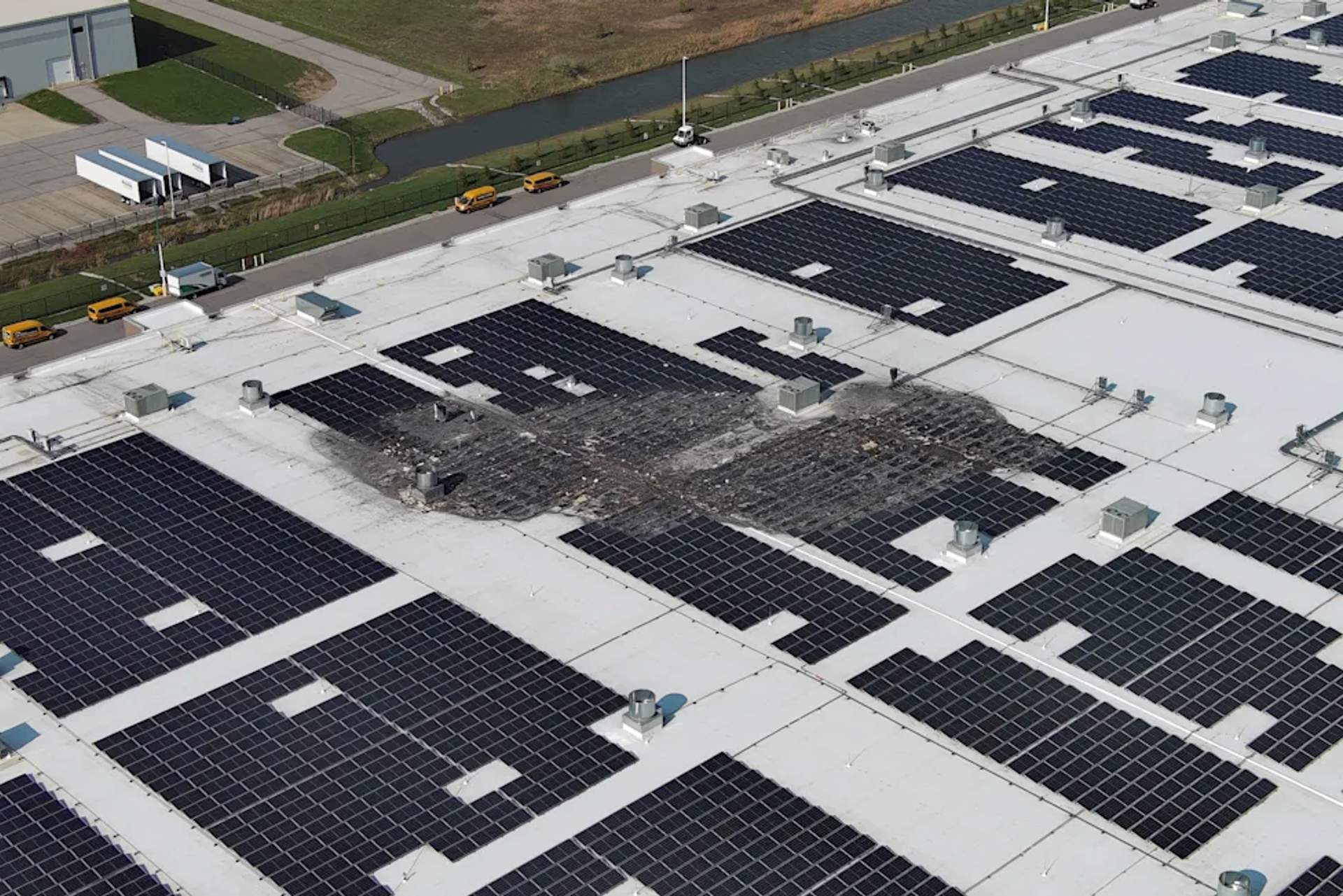 Charred and melted solar panels are visible on the roof of the Amazon fulfillment center in West Jefferson, Ohio, in the aftermath of the April 8, 2026