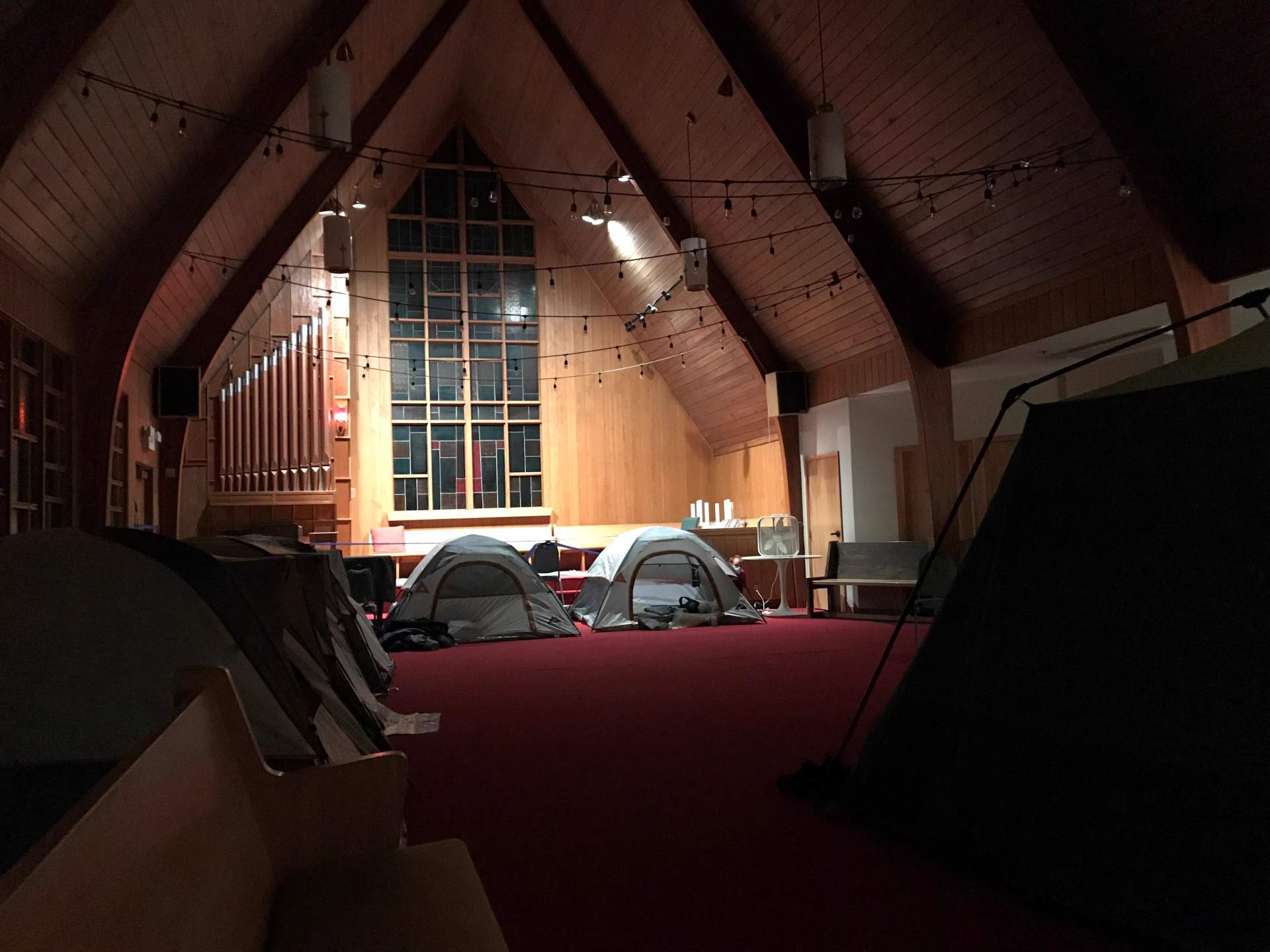 Emergency shelter building housing people experiencing homelessness in Central Oregon, showing shelter facilities and community members