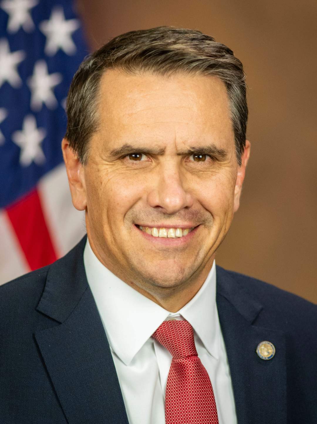 Official DOJ portrait of Todd Blanche wearing a dark suit and tie