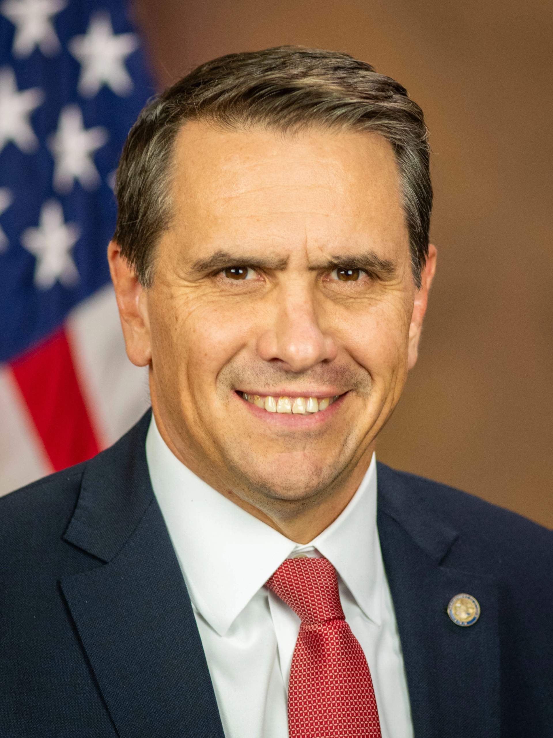 Official DOJ portrait of Todd Blanche wearing a dark suit and tie