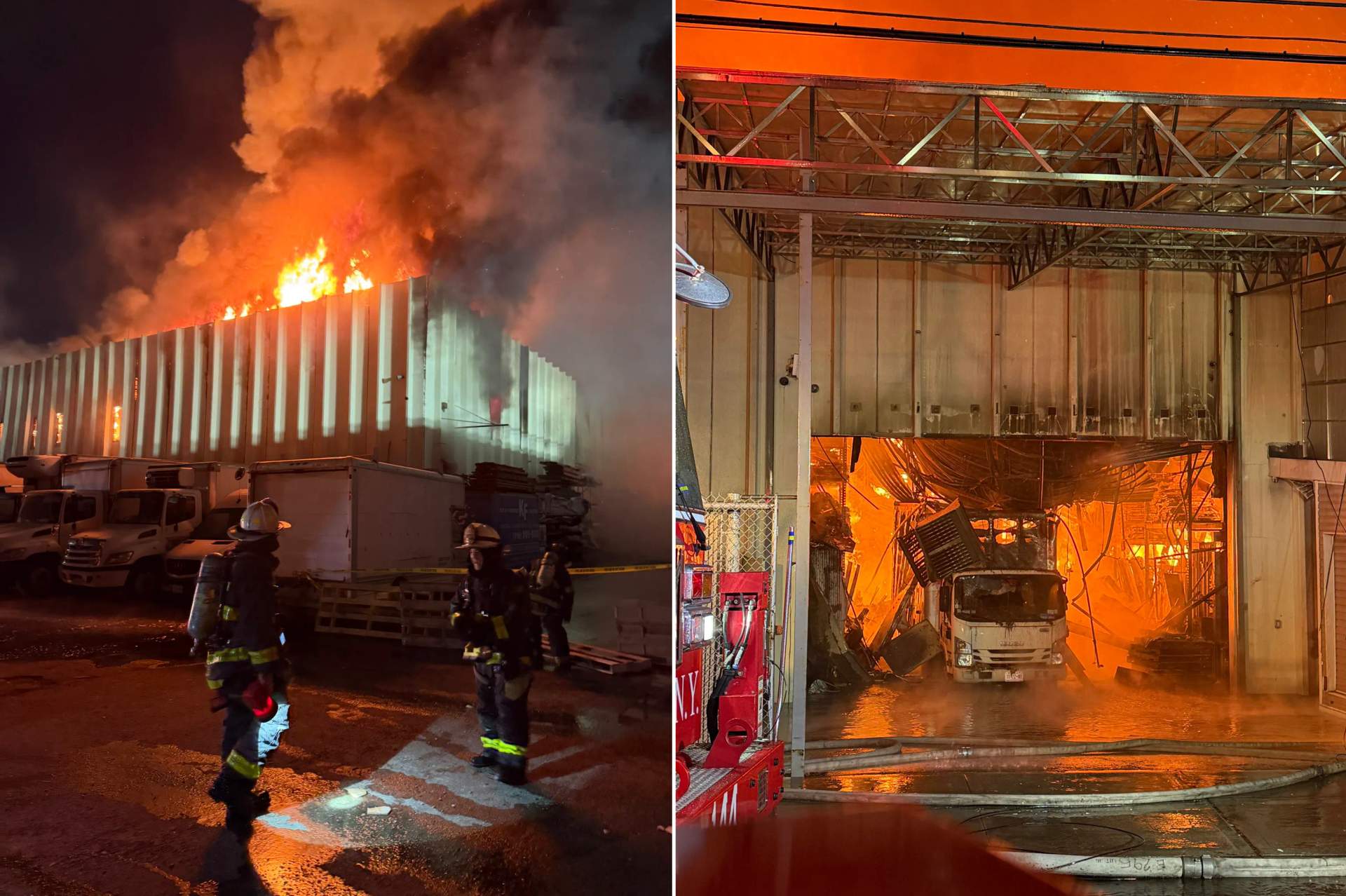 Firefighters in turnout gear and helmets work at night near a large industrial building with emergency lights flashing. Thick smoke is visible in the background as they battle the massive lumberyard fire.
