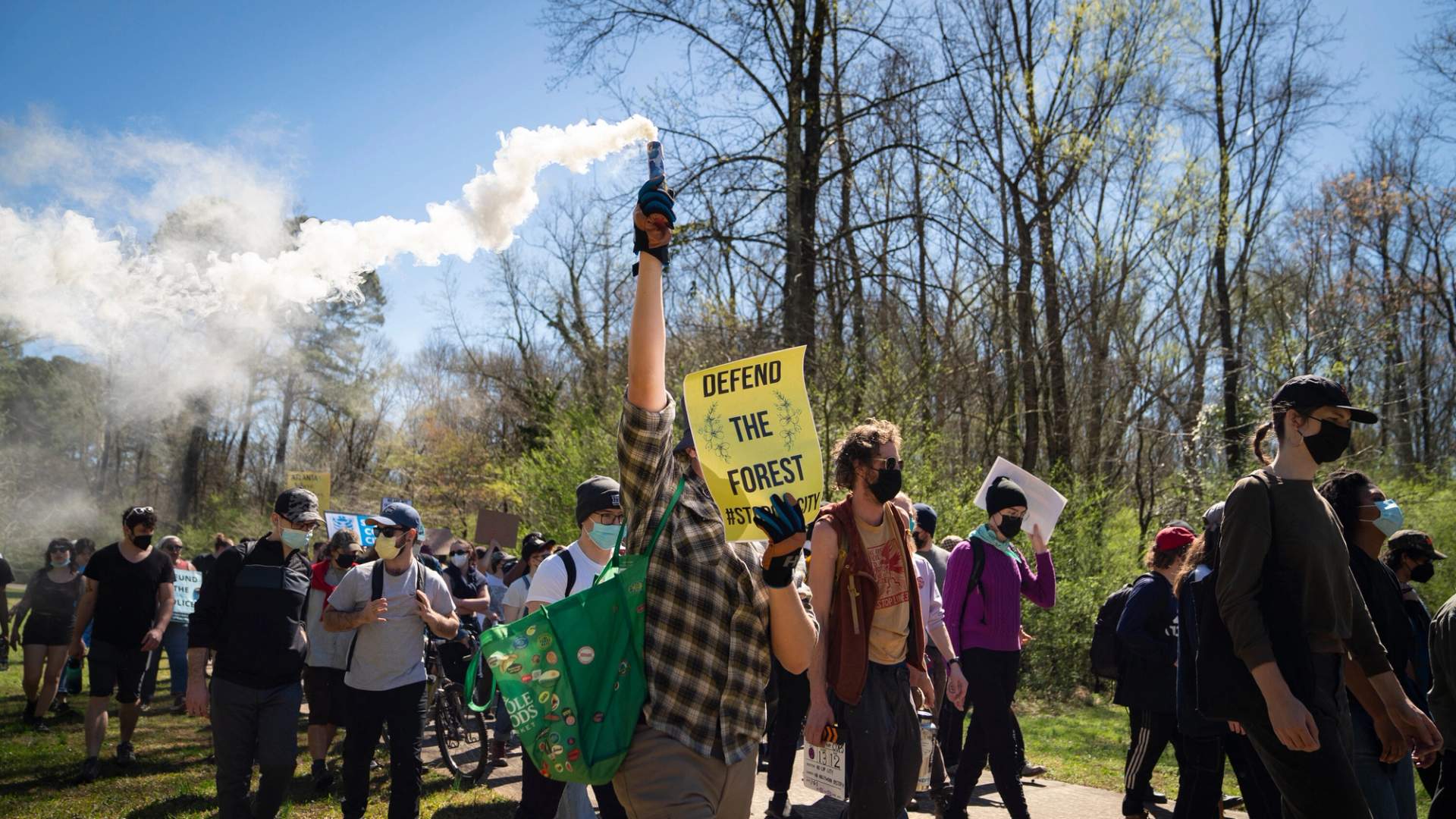Activist march through the forest planting trees