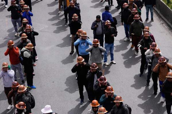 Bolivian miners cover their ears before dynamite detonates during anti-government protests in El Alto, May 2026
