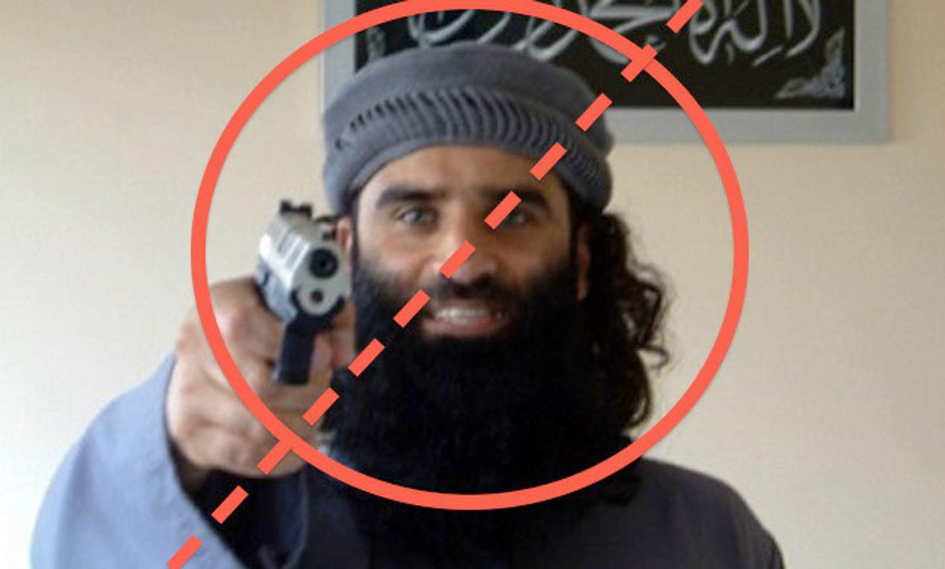 A bearded man in a beanie points a handgun at the camera, circled and crossed out with a red prohibition symbol — a stock image illustrating the 'terrorist suspect' stereotype the article critiques.