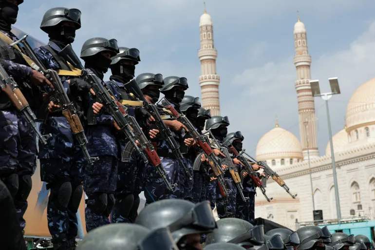 Houthi security force personnel stand guard in the Yemeni capital Sanaa as Houthi supporters rally against the Saudi-led coalition’s restrictions on Houthi-controlled areas, which the group describes as a blockade, July 17, 2026