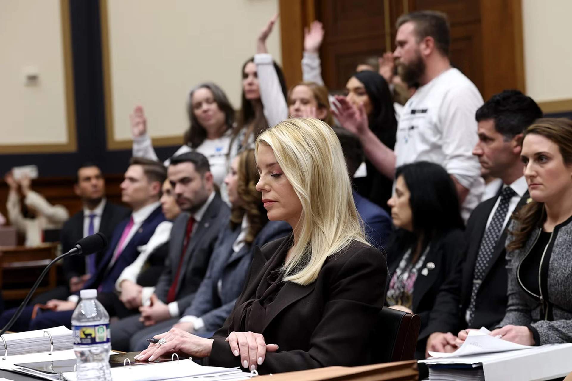 Pam Bondi averts her eyes in shame as Epstein survivors raise hands if she has not interviewed them in the case.