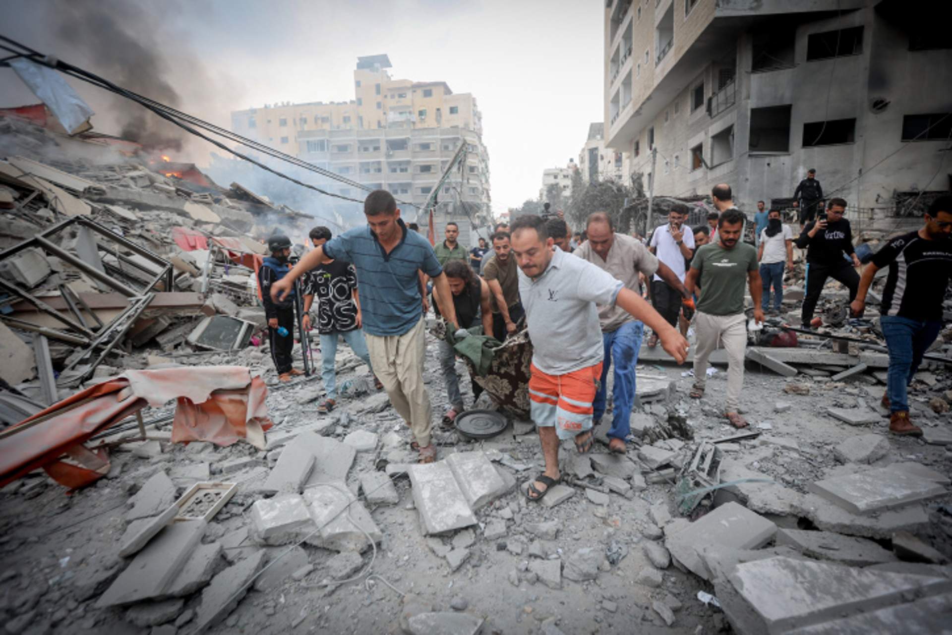 Gazans help the injured in Israeli airstrikes, October 10, 2023