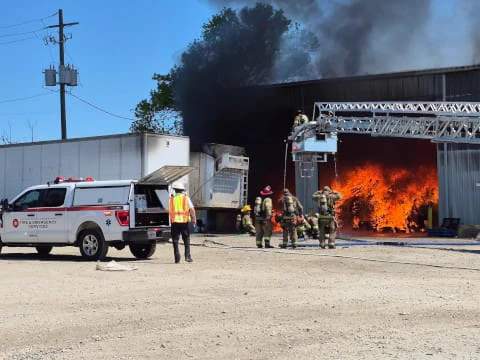 Gwinnett County Fire and Rescue crews battle flames within a commercial structure along Seaboard Industrial Drive in Lawrenceville on Friday, April 10, 2026. (Photo courtesy of Gwinnett County Fire and Emergency Services.)