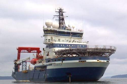 The Fennica, a blue-and-white icebreaker support vessel, in open water.
