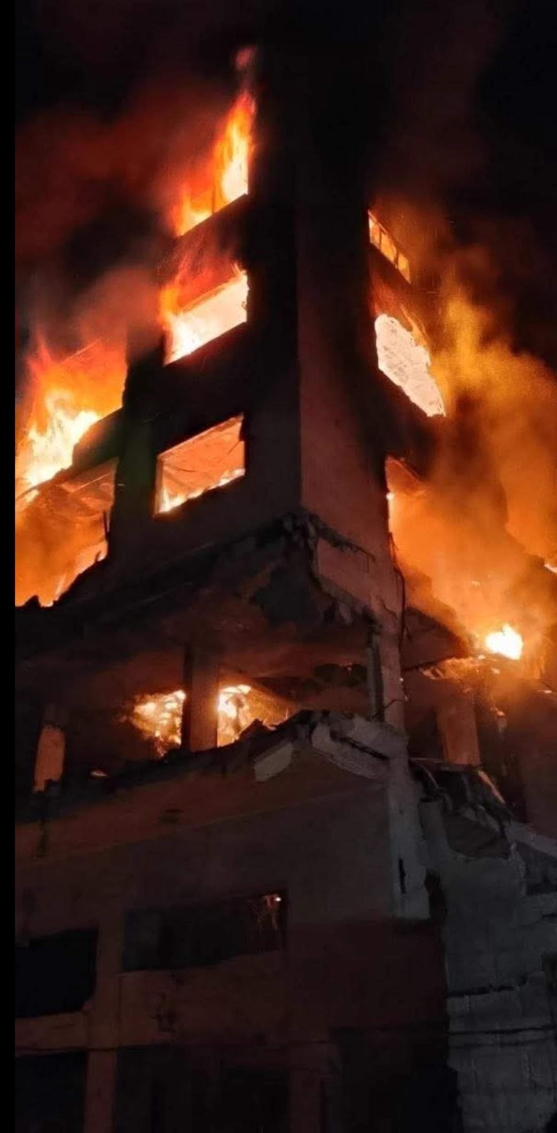 The targeted building fully engulfed in fire, every floor burning, Gaza, May 15, 2026. [Salah Akram - UnTelevised Media]