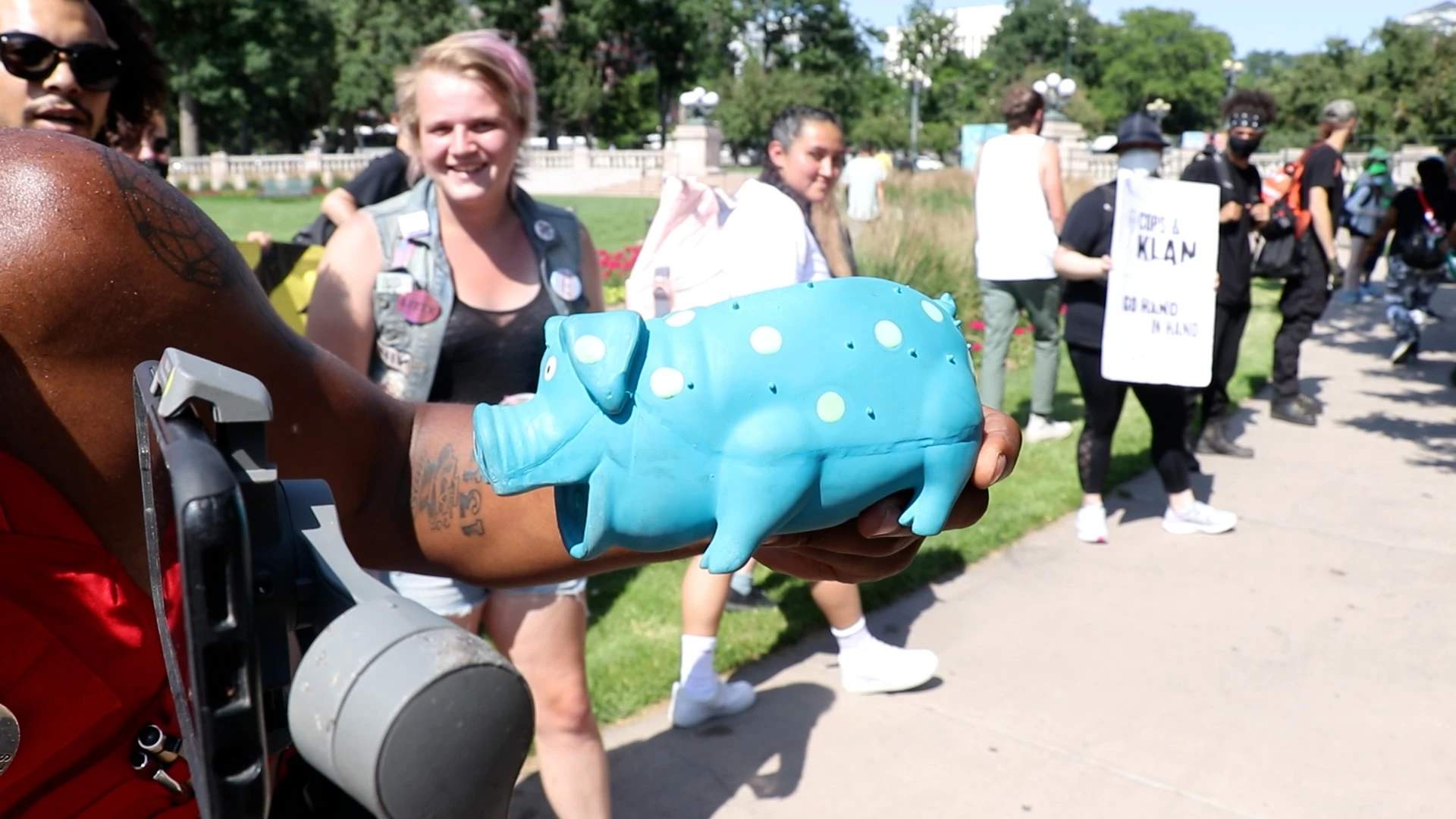 A larger toy pig being used to make jokes by local activist on live stream.