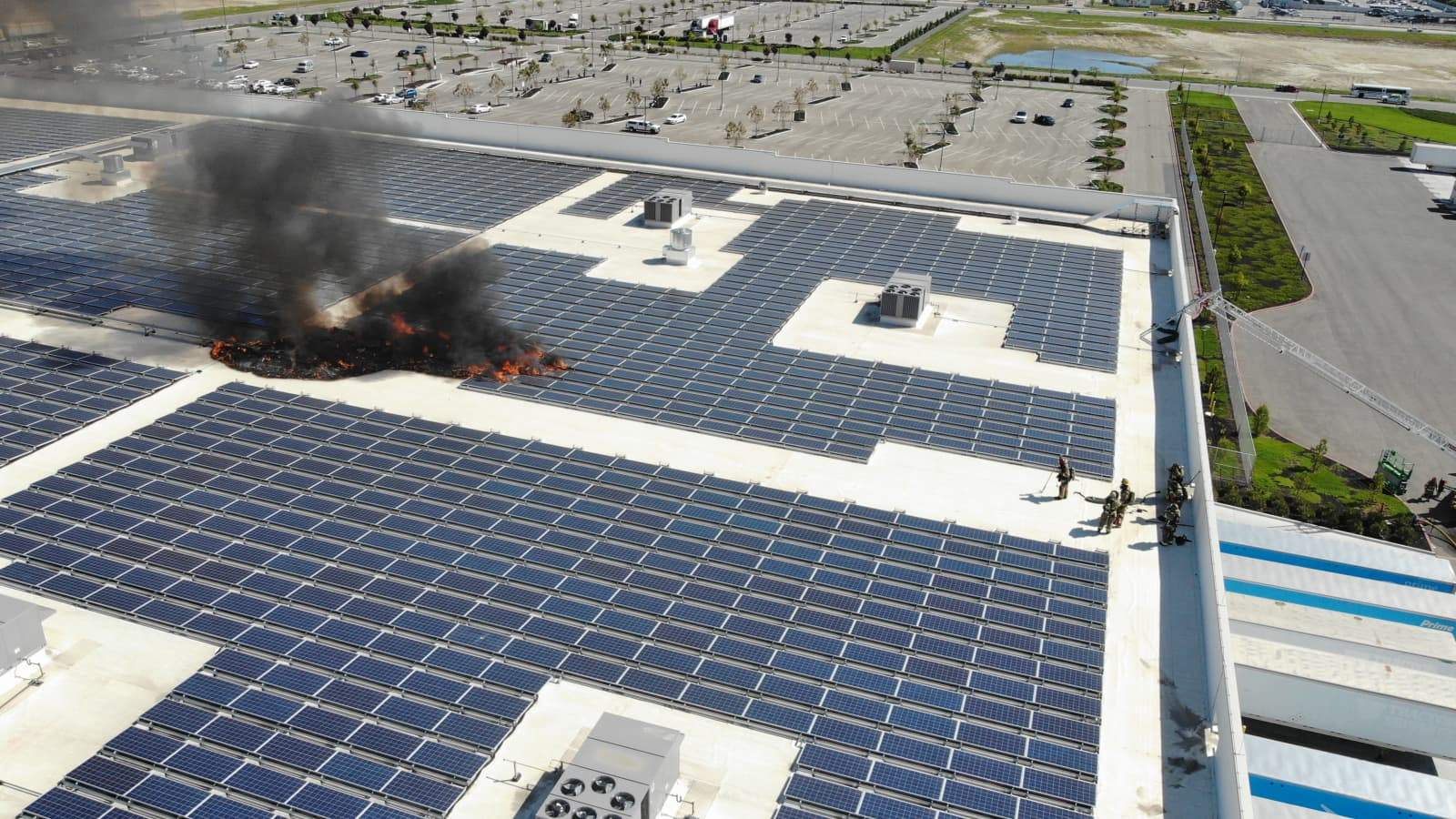 Thick black smoke billows from the roof of the Amazon fulfillment center in West Jefferson, Ohio, as dozens of solar panels burn on April 8, 2026