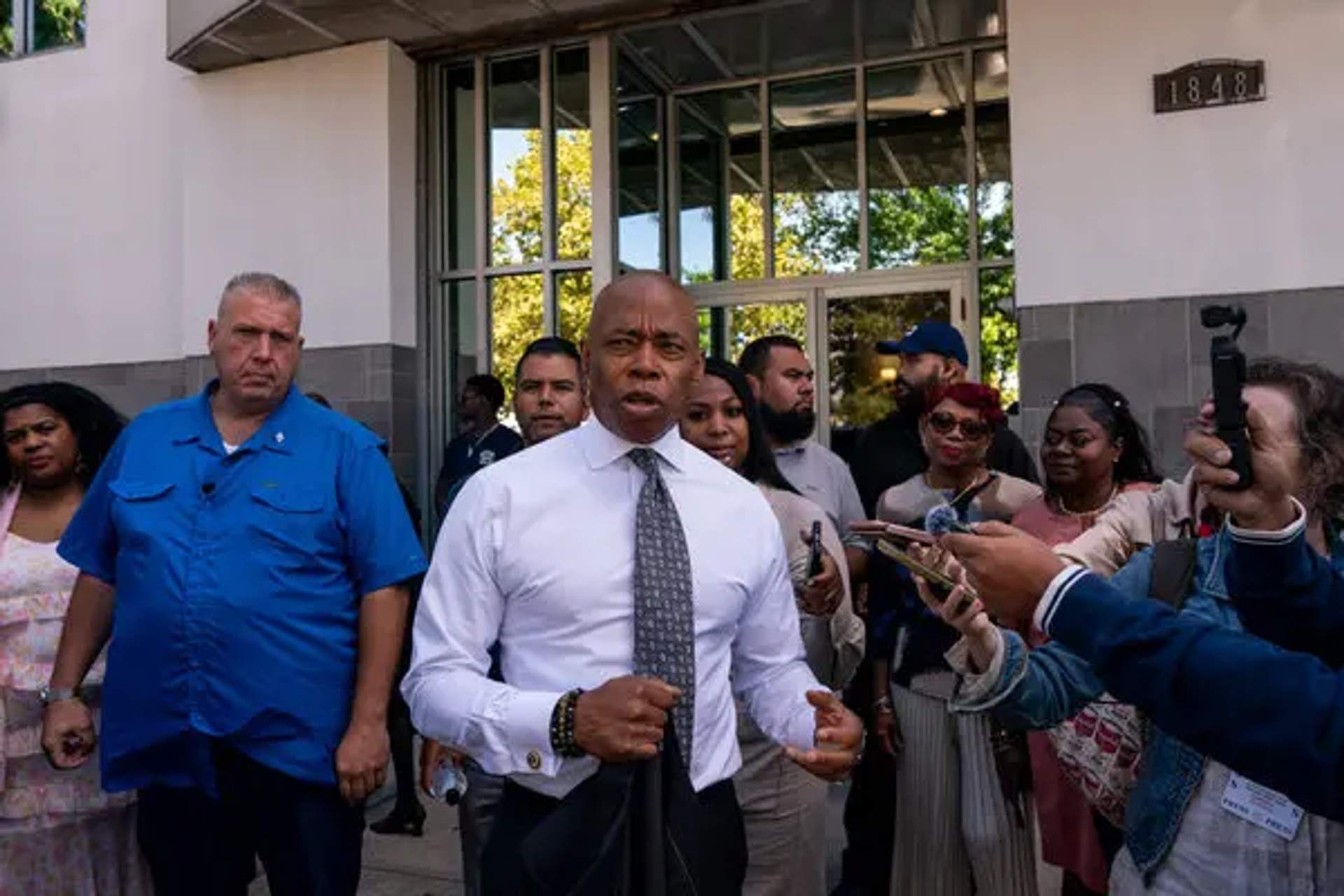 Adams speaking to the media outside of Changing Lives Christian Center.