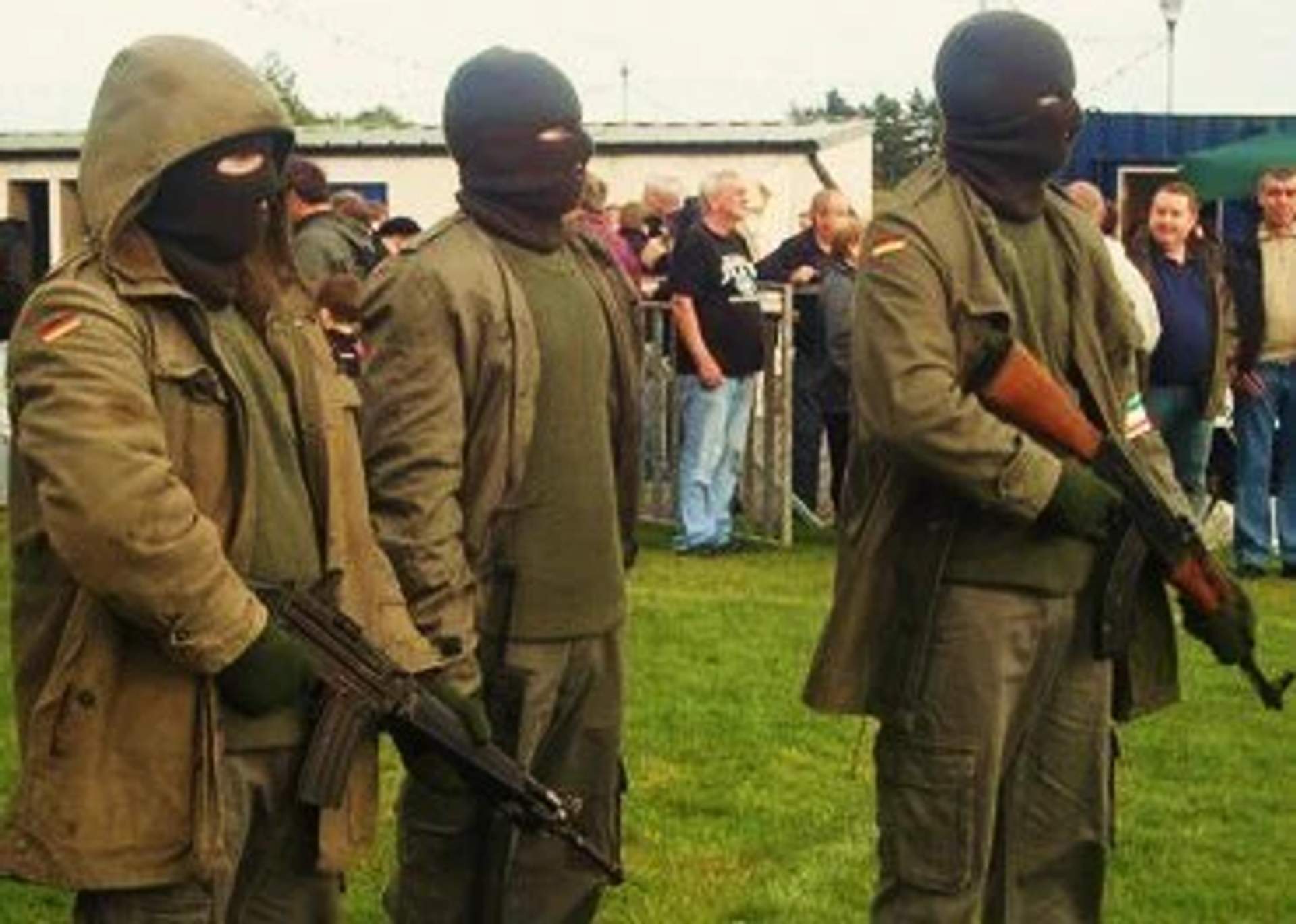Provisional IRA standing with guns and in matching fatigues