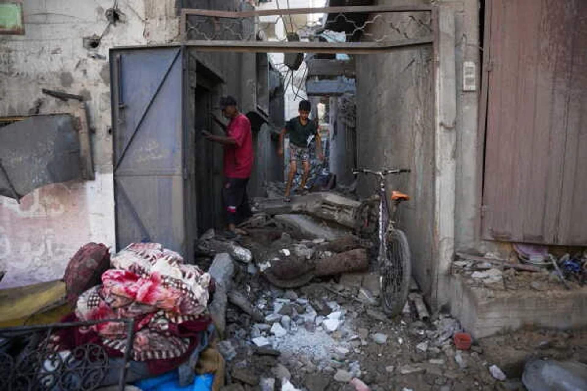 Palestinians inspect destroyed buildings at the scene of an Israeli airstrike in Nuseirat, central Gaza Strip, August 1, 2026