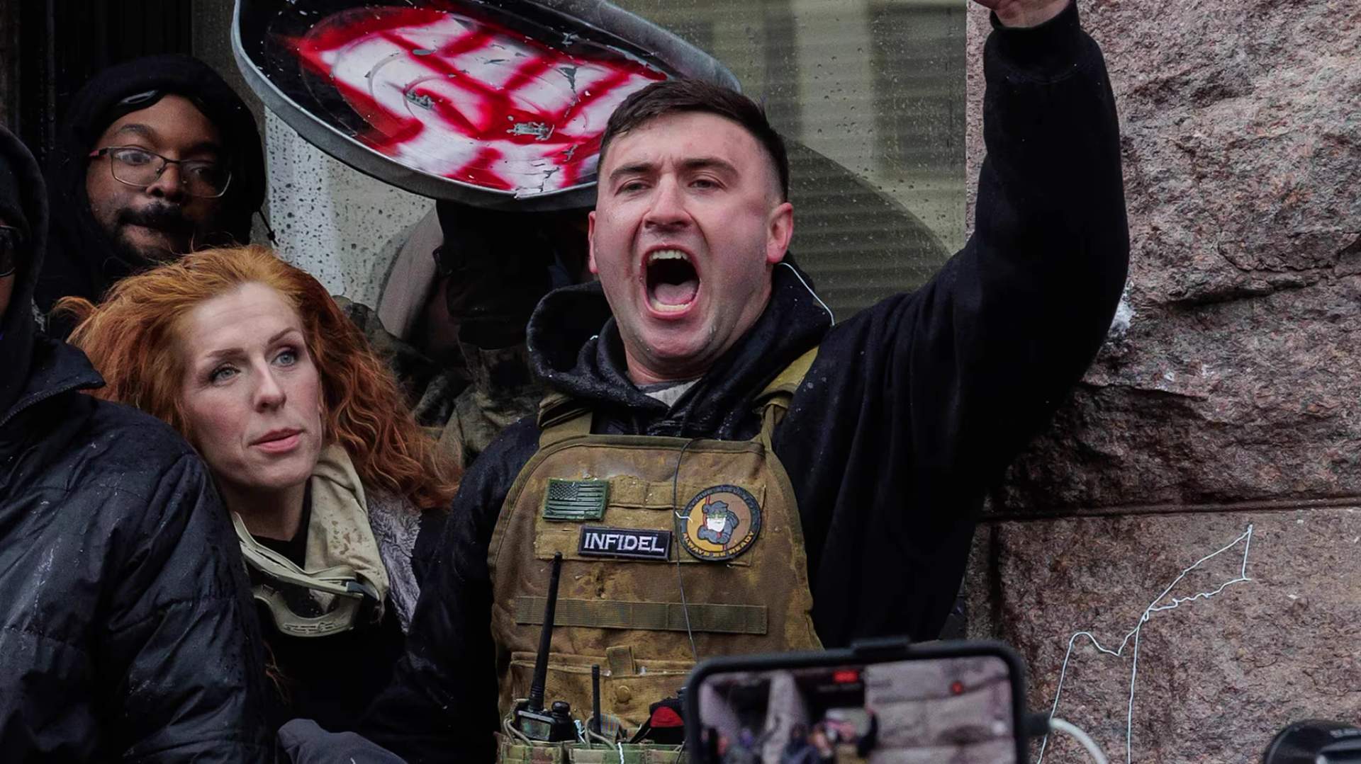 Jake Lang carrying racist signs outside the BET Awards venue in Los Angeles on June 28, 2026, before being confronted and chased away by the crowd