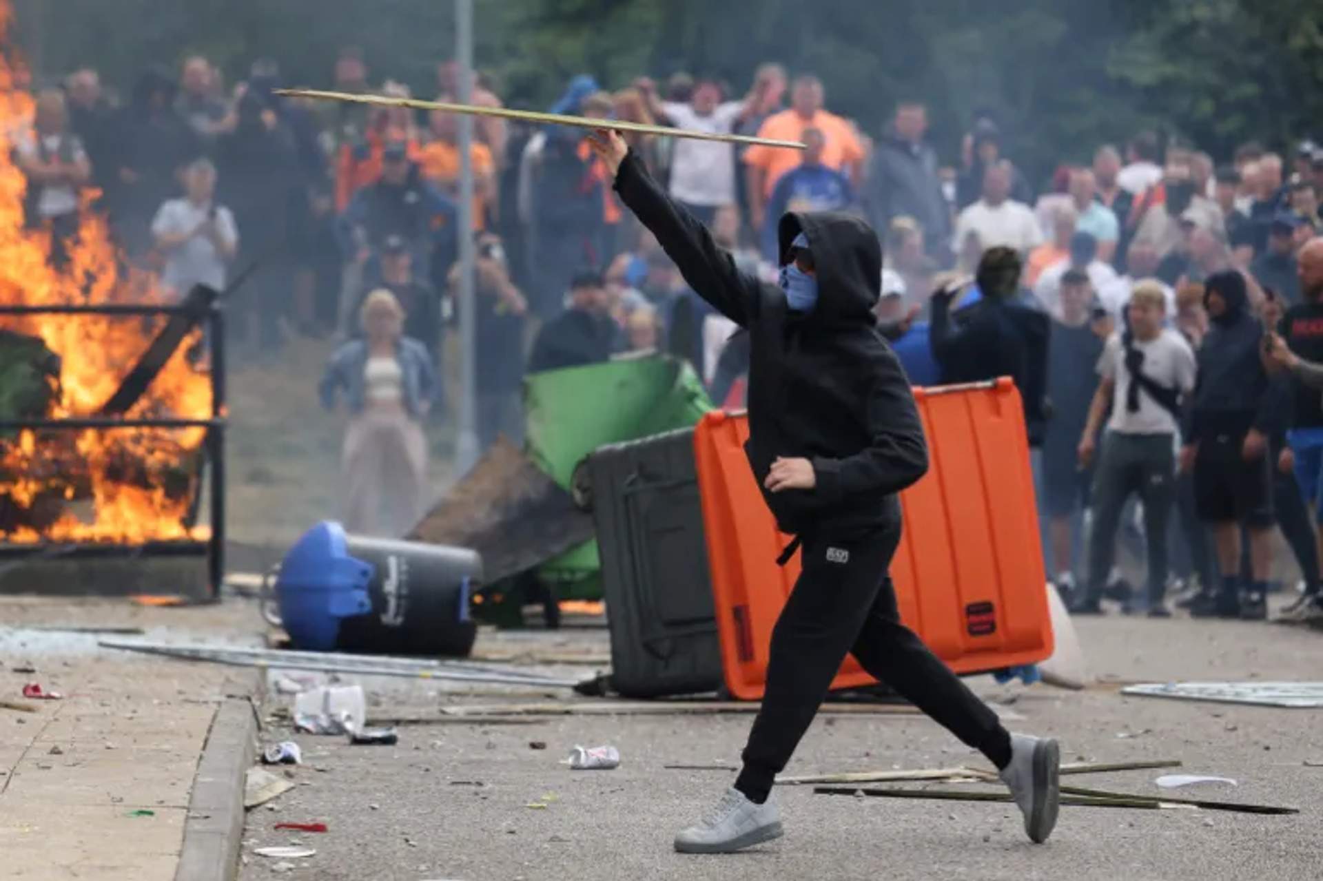 Flames burn as demonstrators take part in an anti-immigration protest [Rotherham, UK - August 4, 2024]
