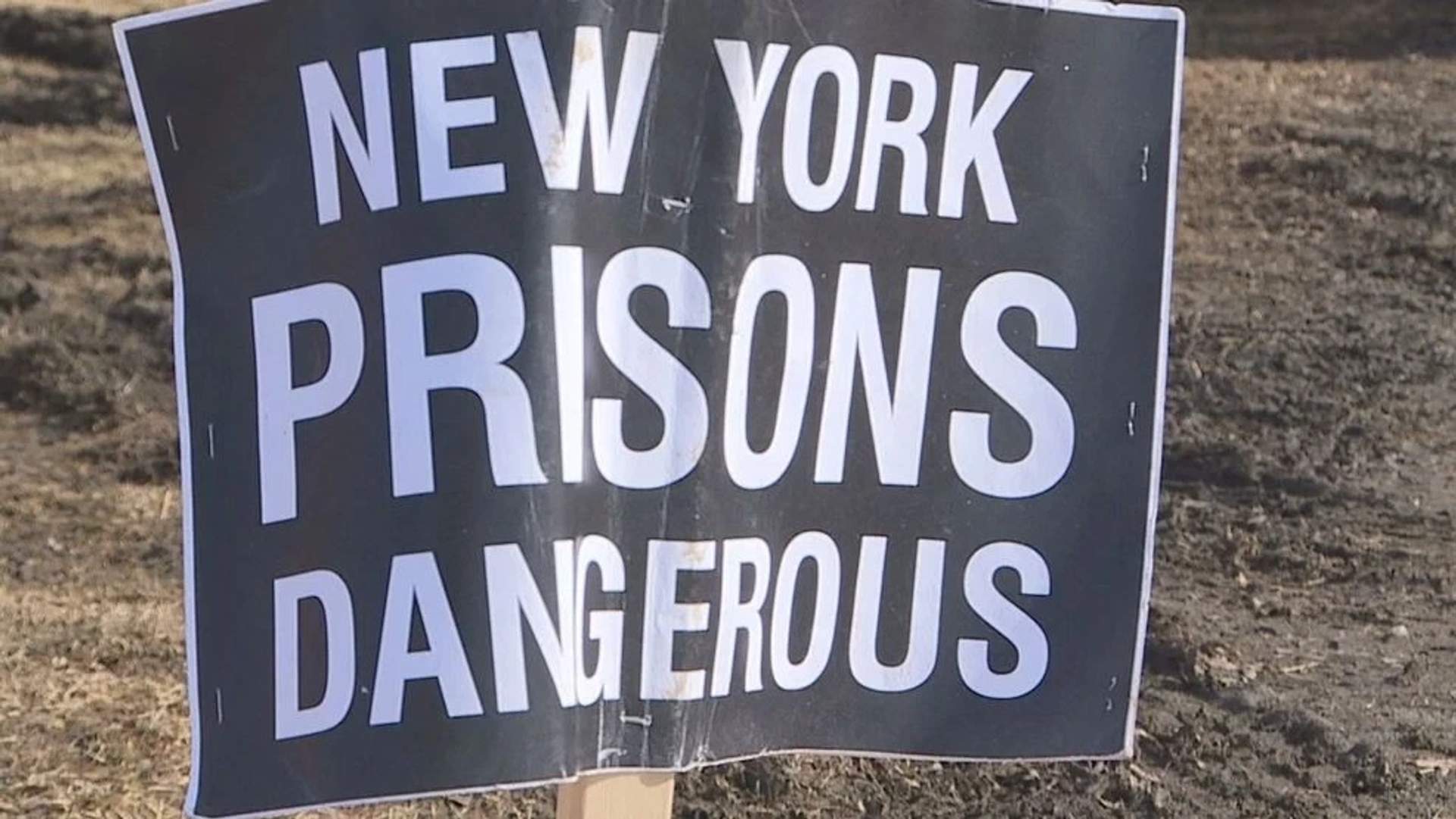 Close up of protest sign reading "New York Prisons Dangerous"