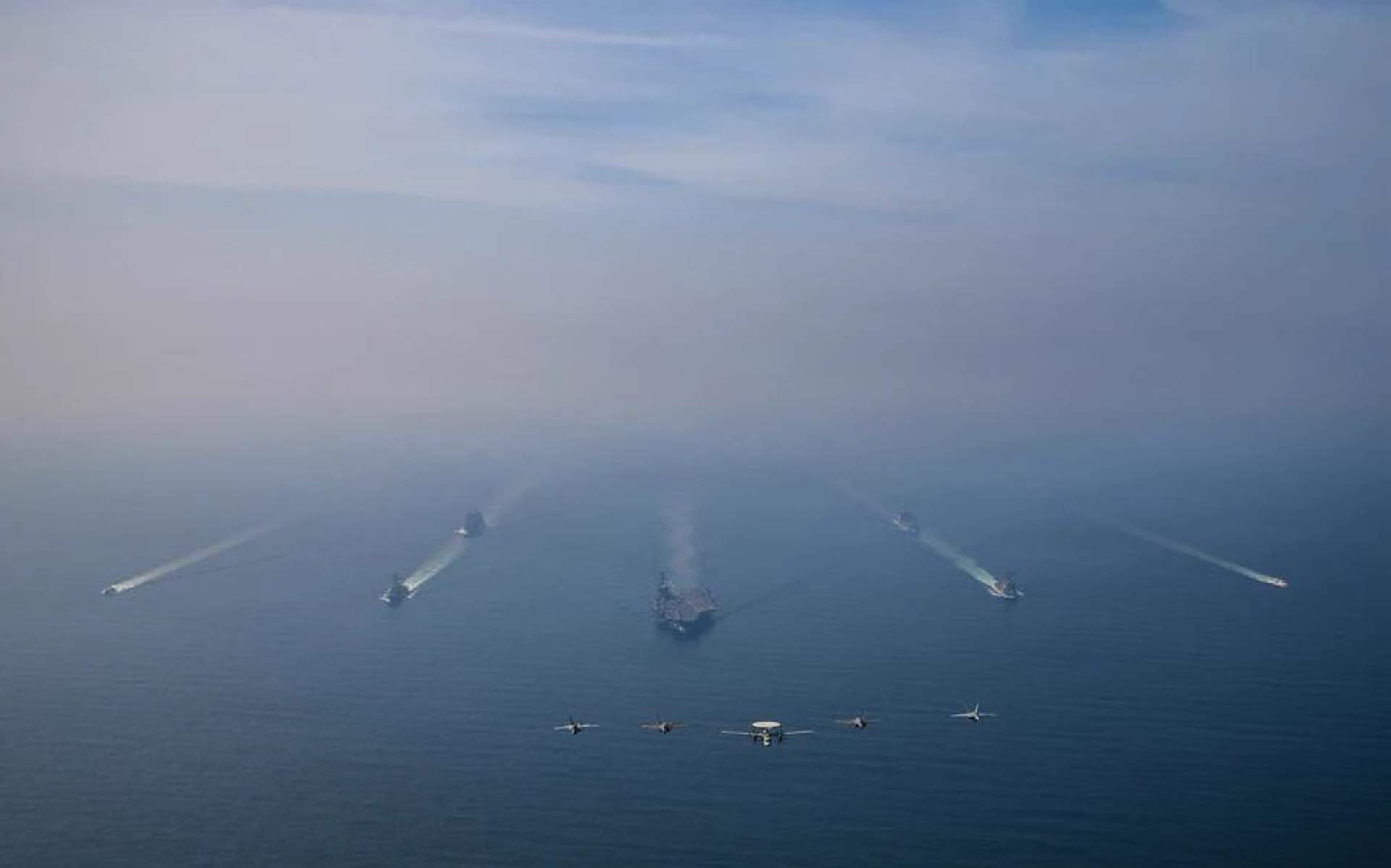 The USS Abraham Lincoln and Carrier Air Wing 9 transiting in formation at sea