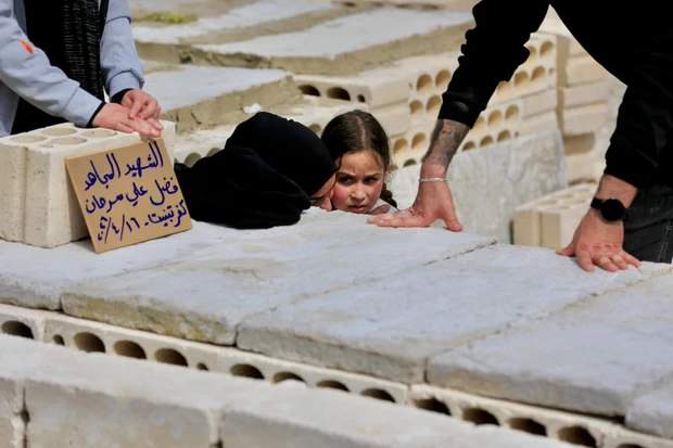 Mourners attending the funeral of Fadel Sarhan in Haret Saida, southern Lebanon.