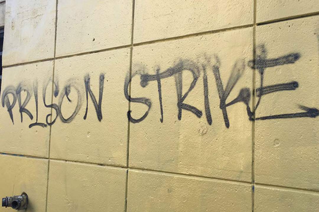 Prison Strike Graffiti written on prison bathroom wall.