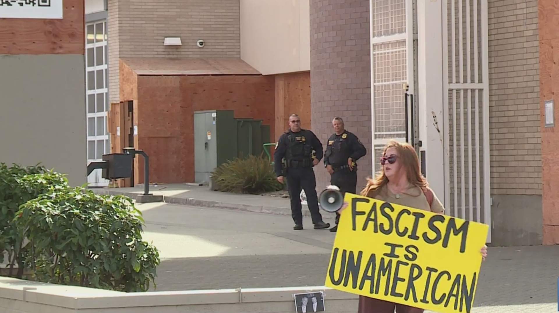 Protesters gathered outside ICE detention facility holding signs in Portland Oregon