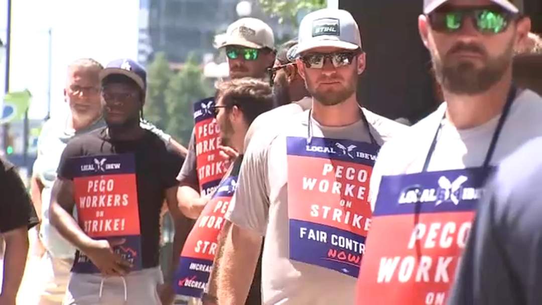 Striking PECO workers carrying signs on a picket line outside company headquarters in Philadelphia on July 4, 2026