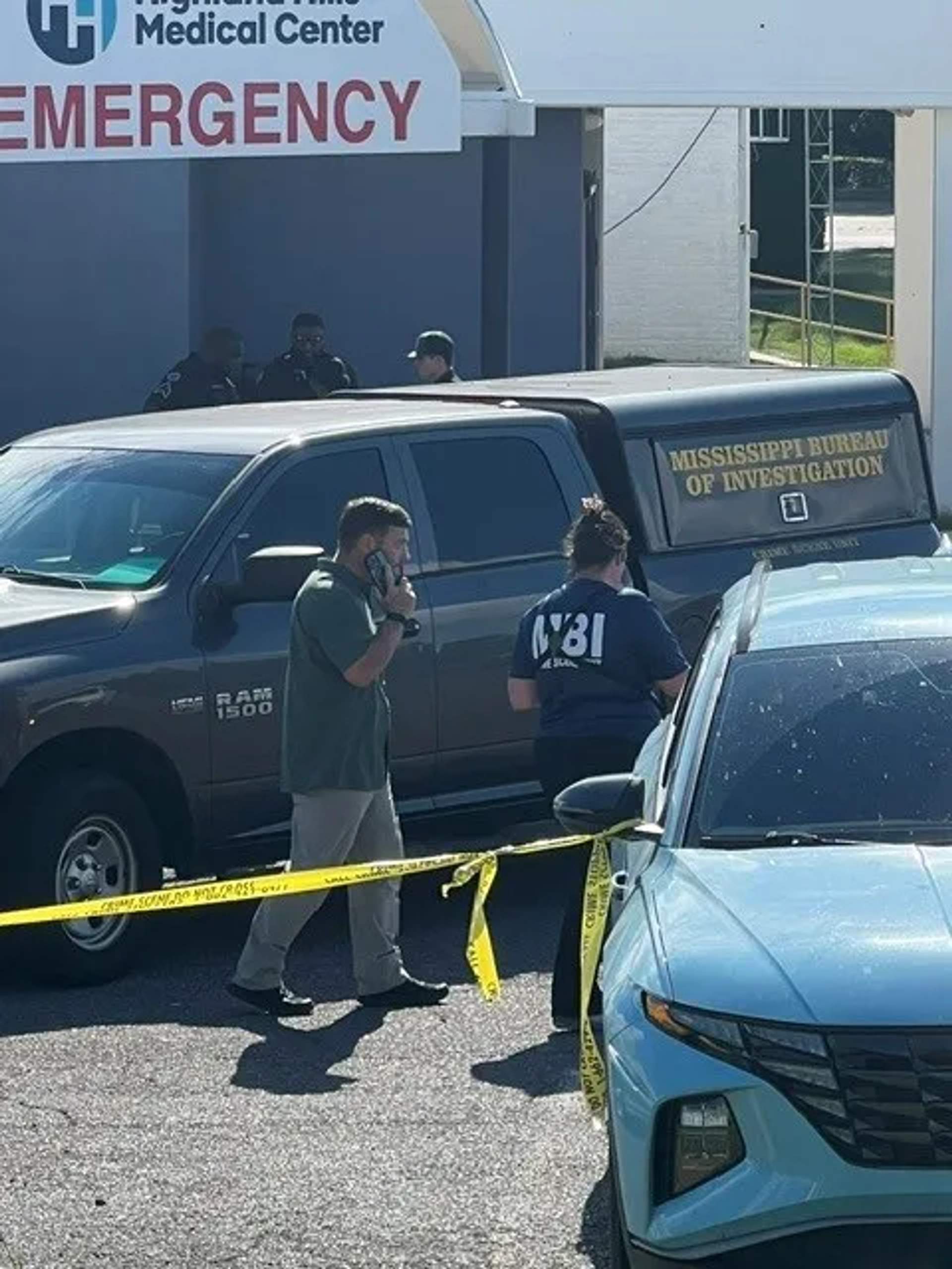 Mississippi Bureau of Investigation vehicles and agents at a hospital entrance in Senatobia, Mississippi.