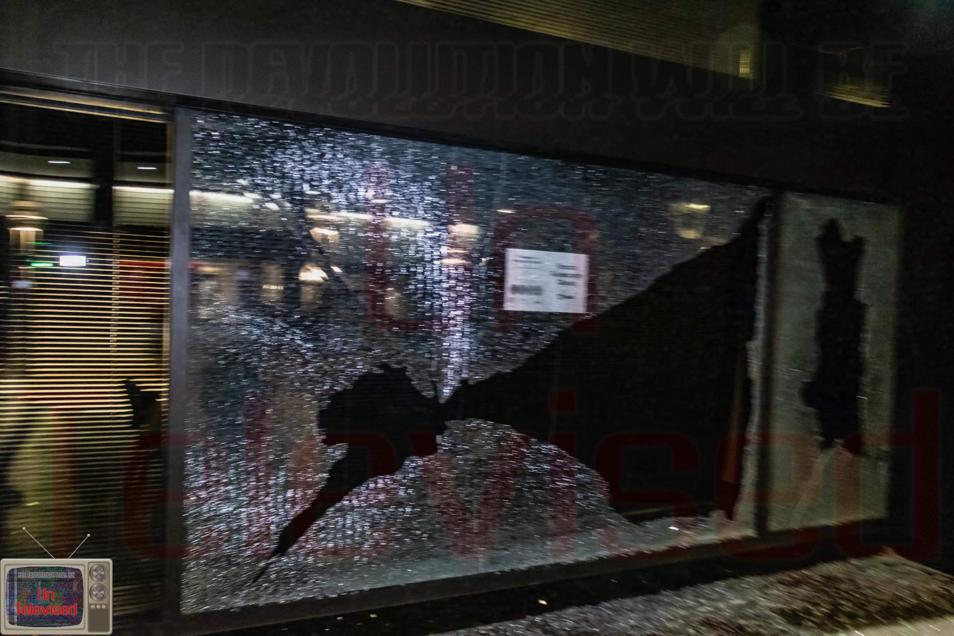 US Bank with a large jagged hole punched through the shattered glass.  [Radical Edward - Untelevised Media]