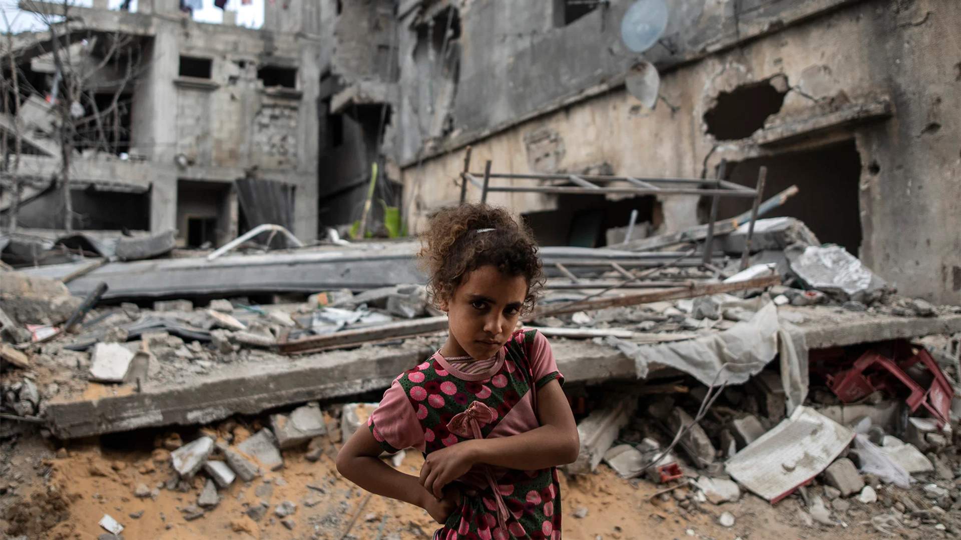 Palestinian Rahaf Nuseir, 10, looks on as she stands in front of her family's destroyed homes, to which they returned following a cease-fire reached after an 11-day war between Gaza's Hamas rulers and Israel, in town of Beit Hanoun, northern Gaza Strip, Friday, May 21, 2021. [AP Photo - Khalil Hamra]
