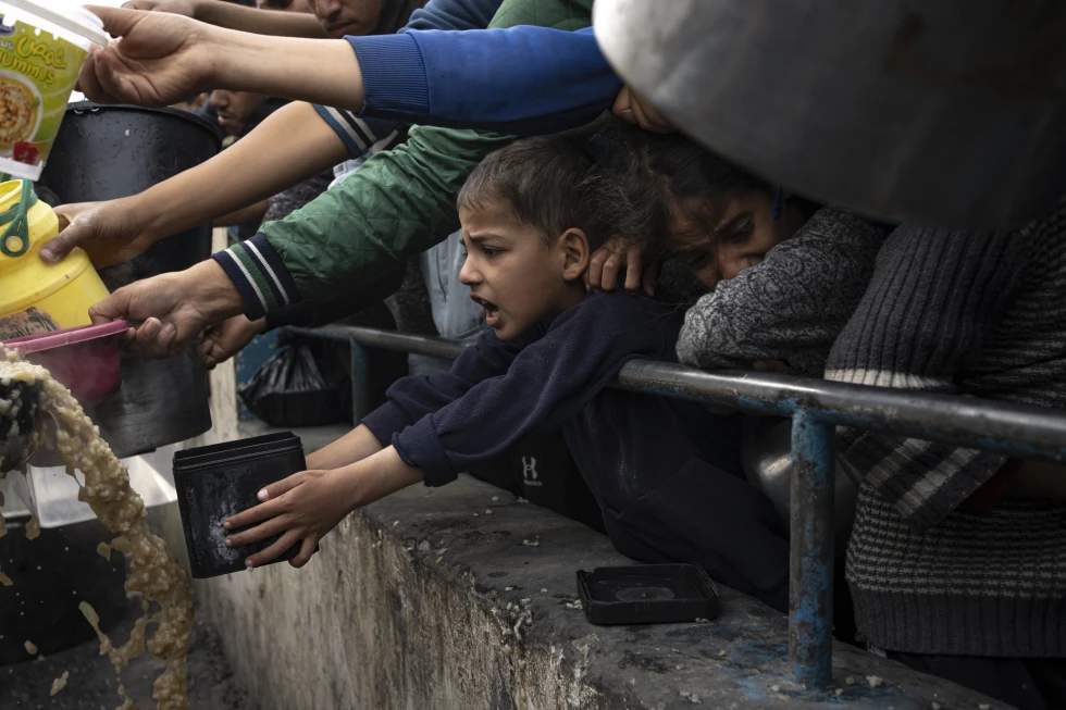 Palestinians line up for a free meal in Rafah, Gaza Strip, on Thursday, December 21, 2023. I