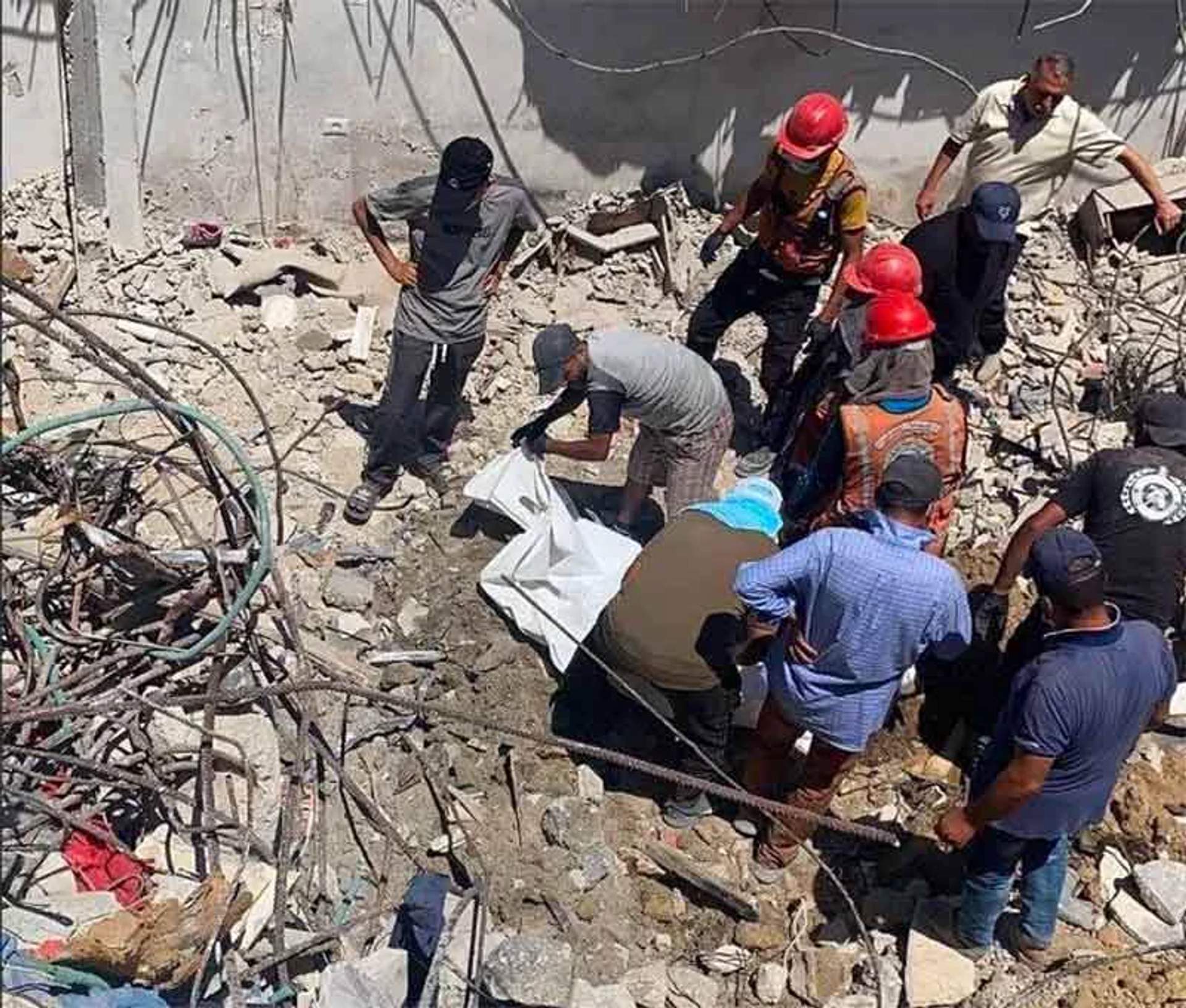 Gaza Civil Defense teams work to recover bodies from the rubble of the al-Hasayna family homes in Sabra neighborhood, Gaza City, August 2026